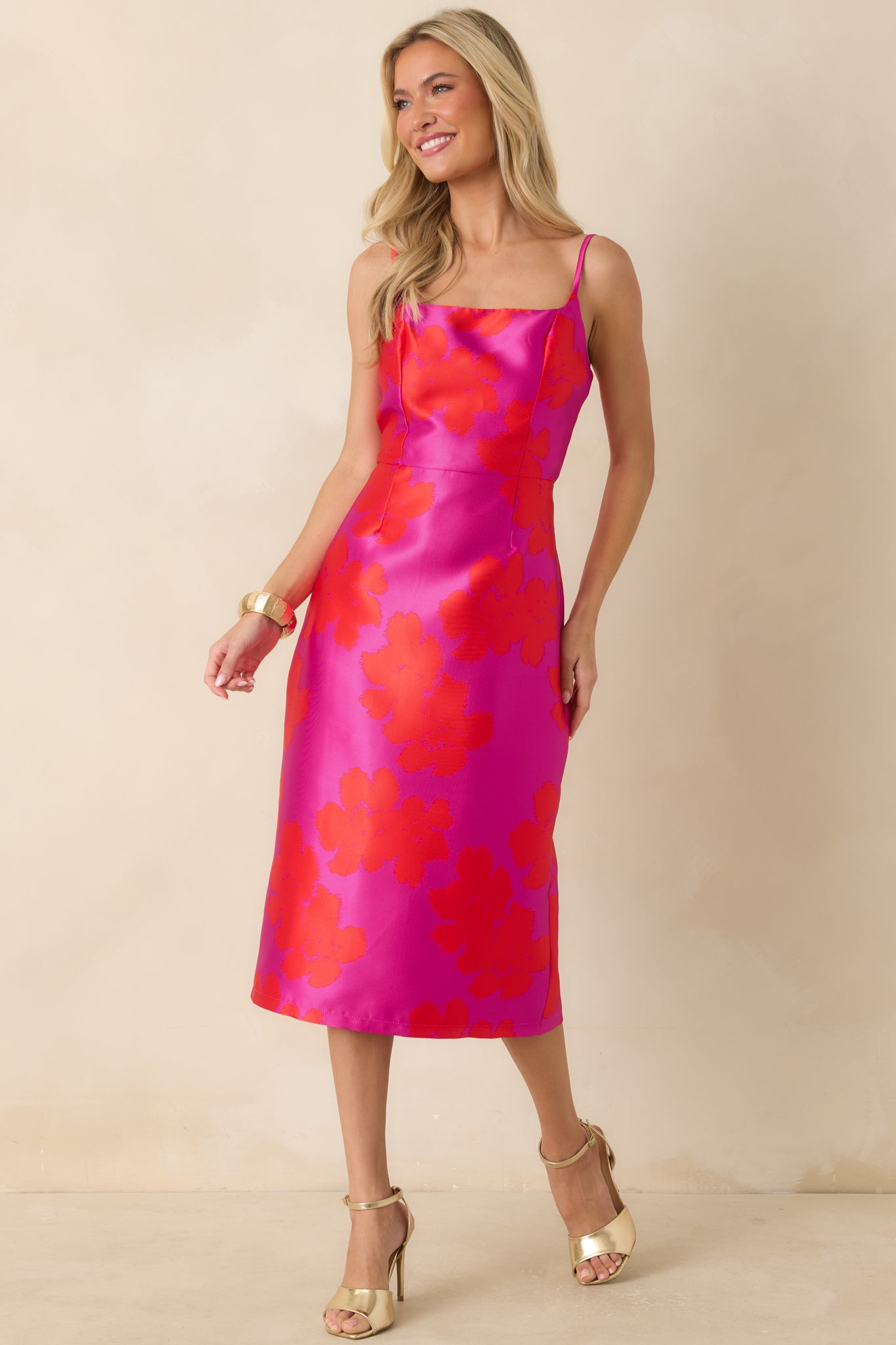 Red and fuchsia jacquard dress featuring delicate spaghetti straps, a tailored silhouette, and elegant floral texture throughout.