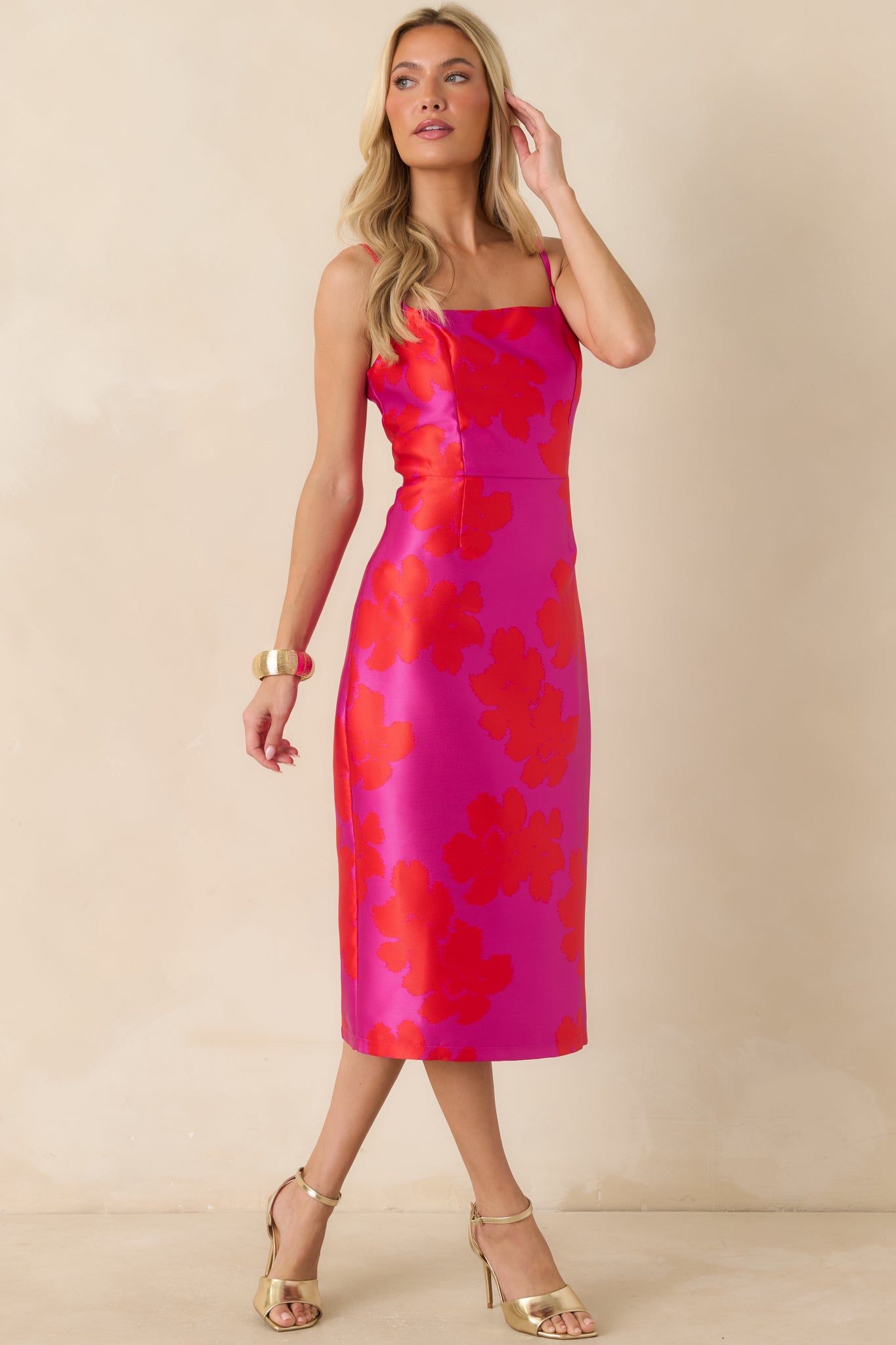 Floral midi dress with a square neckline, fitted bodice, and a streamlined shape that follows the body to a midi hem.