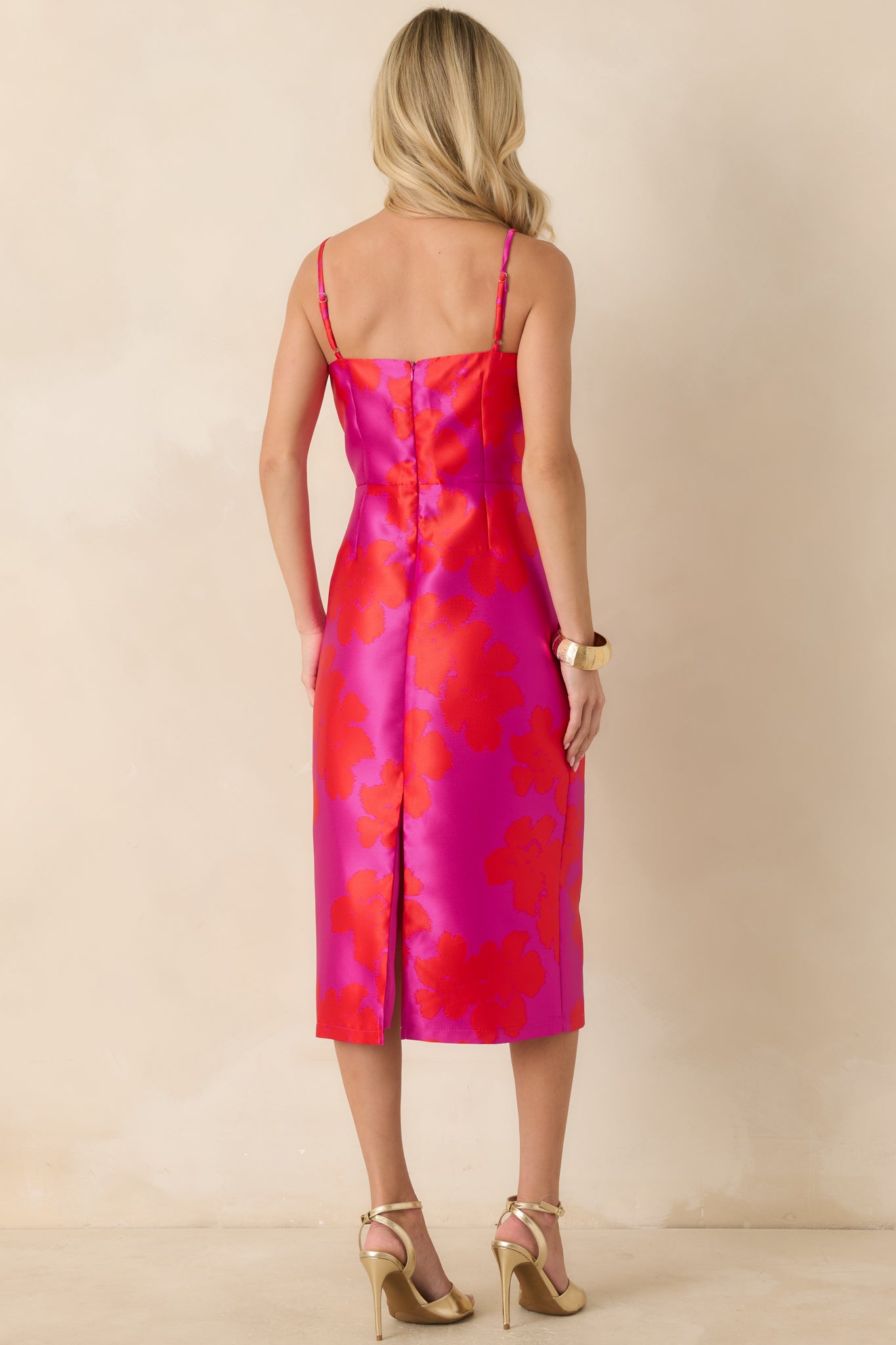 Rear view of the midi dress featuring a back zipper closure, back slit detail, and fitted floral jacquard silhouette.