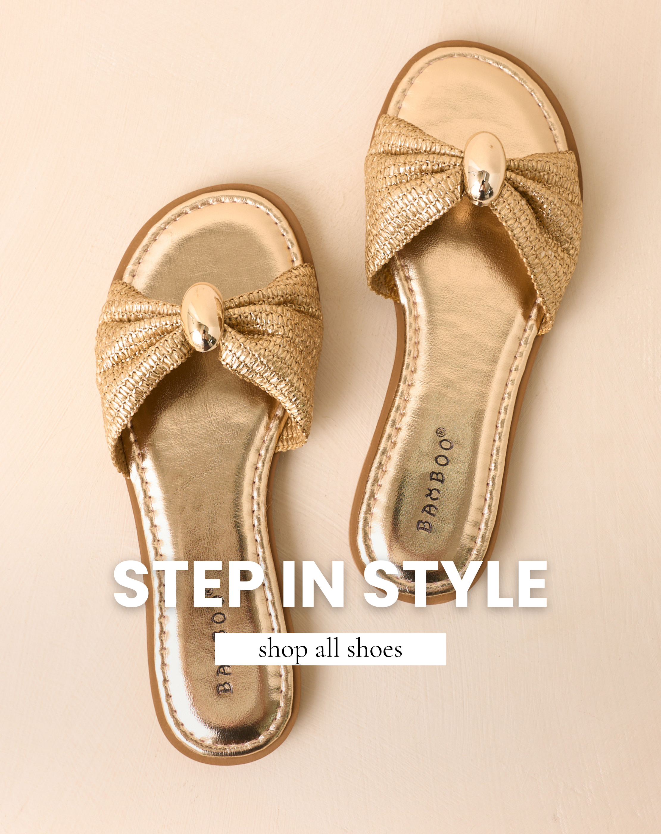 Gold sandals against a beige backdrop.