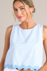 Close up angled view of this light blue stripe tank that features a crew neckline, a wide sleeve, a discrete zipper down the back, and a ricrac hemline.