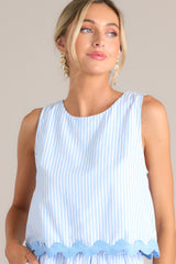 Close up view of this light blue stripe tank that features a crew neckline, a wide sleeve, a discrete zipper down the back, and a ricrac hemline.