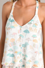 Close up view of the pattern of this tank with v-neckline, thin straps, button front, and super soft fabric.