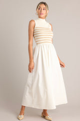 Angled front view of this dress that features a high neckline, a striped sweater bodice, and a flowy skirt.