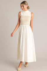 Full body view of this dress that features a high neckline, a striped sweater bodice, and a flowy skirt.