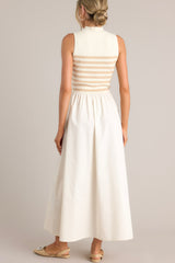 Back view of this dress that features a high neckline, a striped sweater bodice, and a flowy skirt.