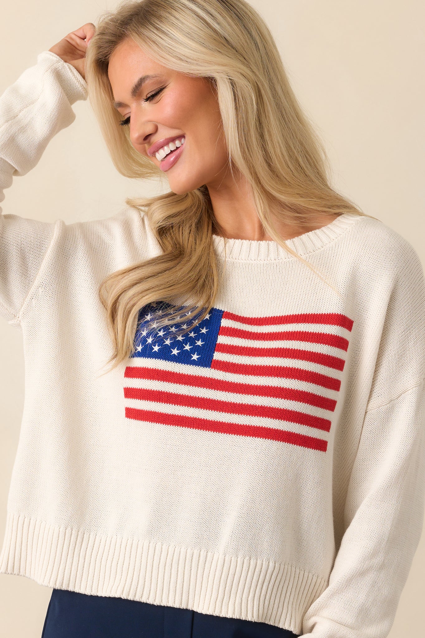 Sleeve and side view of the sweater showing the long sleeve’s shape and relaxed fit at the shoulder.