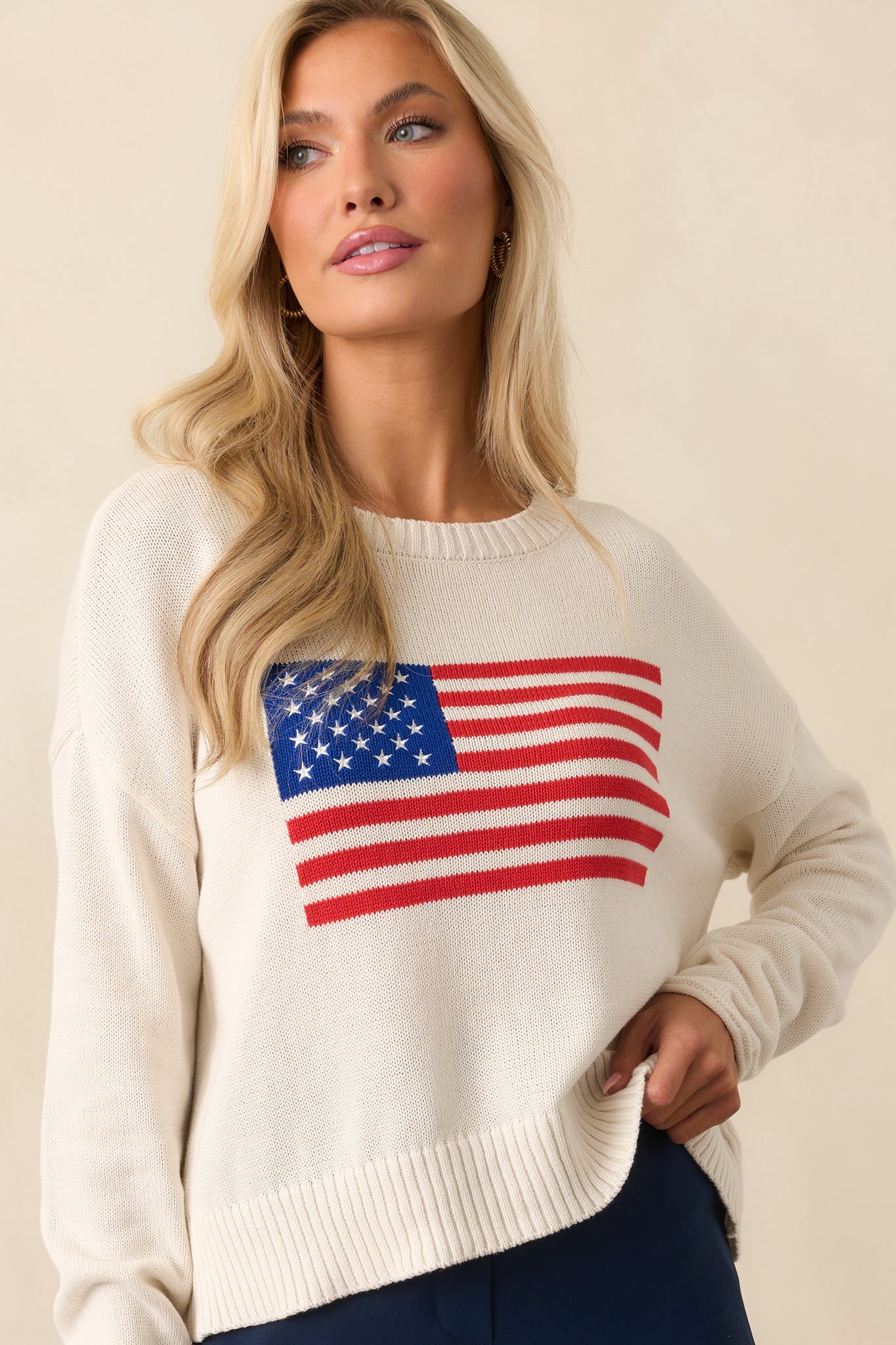 Lower portion of the sweater highlighting the ribbed hem and subtle drape of the relaxed fit.