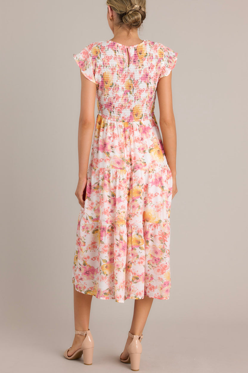 Pink tiered midi dress with a smocked waist and a V-neck