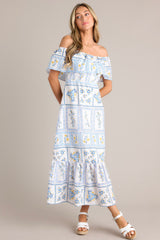 This white & blue maxi dress features an elastic off-the-shoulder neckline, a frilled overlay that forms a false sleeve, an elastic stretch waist, an embroidered floral design, and a lined and tiered skirt.