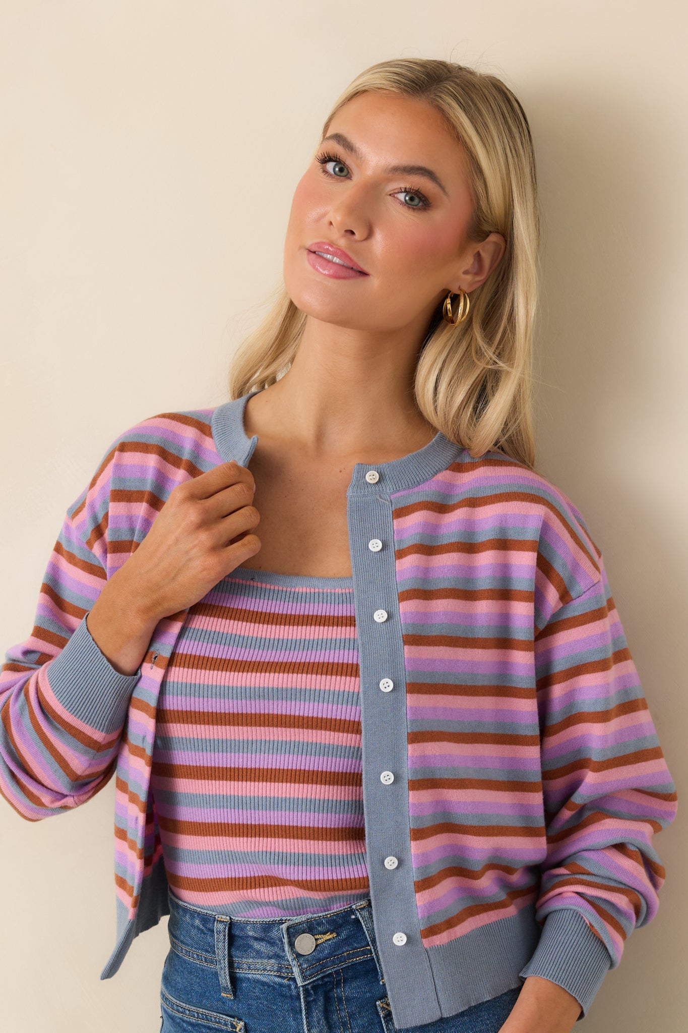 Cardigan highlighting soft striped pattern and button-front closure.