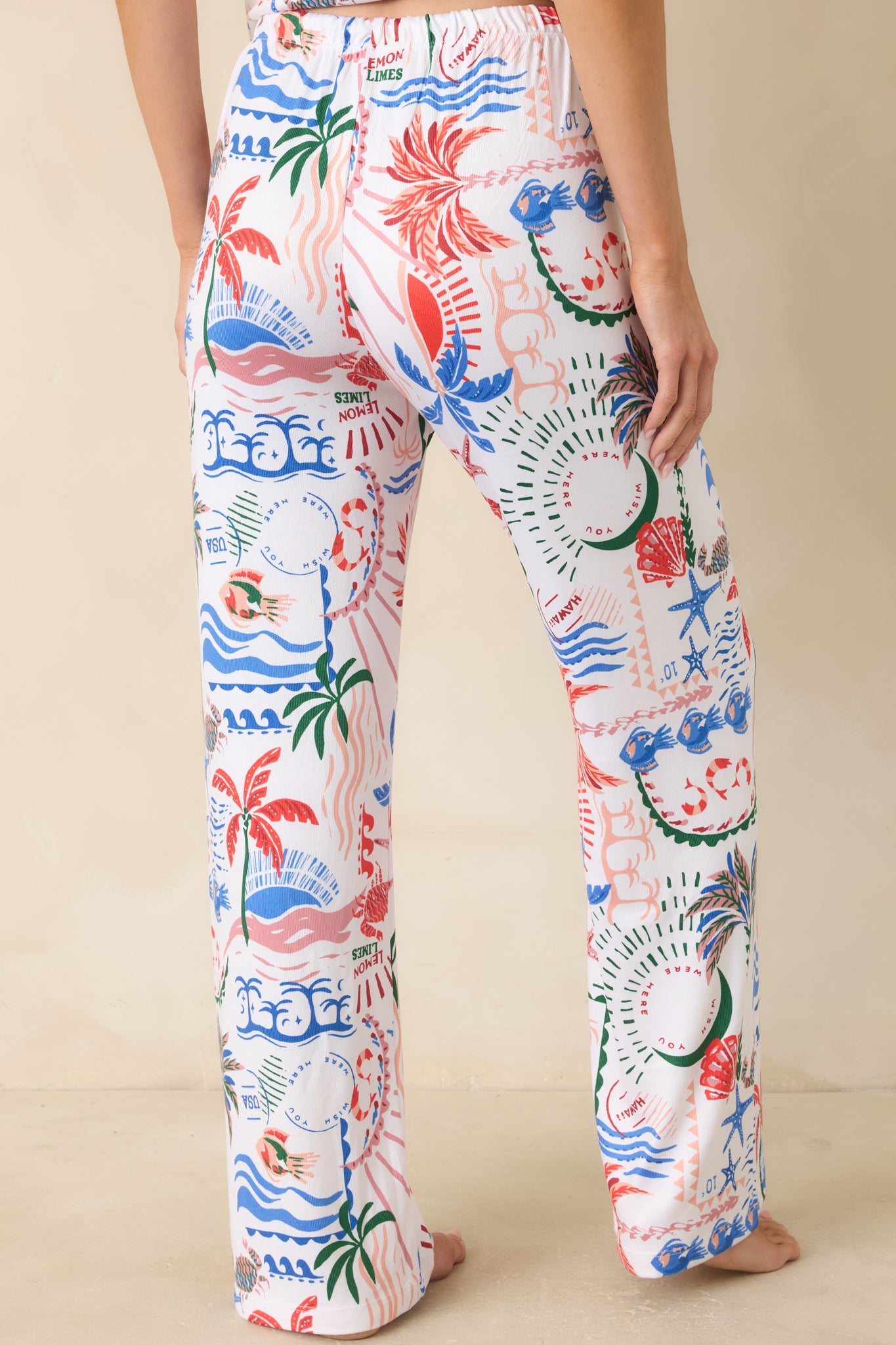 Rear view of the white tropical print pajama pants with relaxed fit and comfortable elastic waistband.

