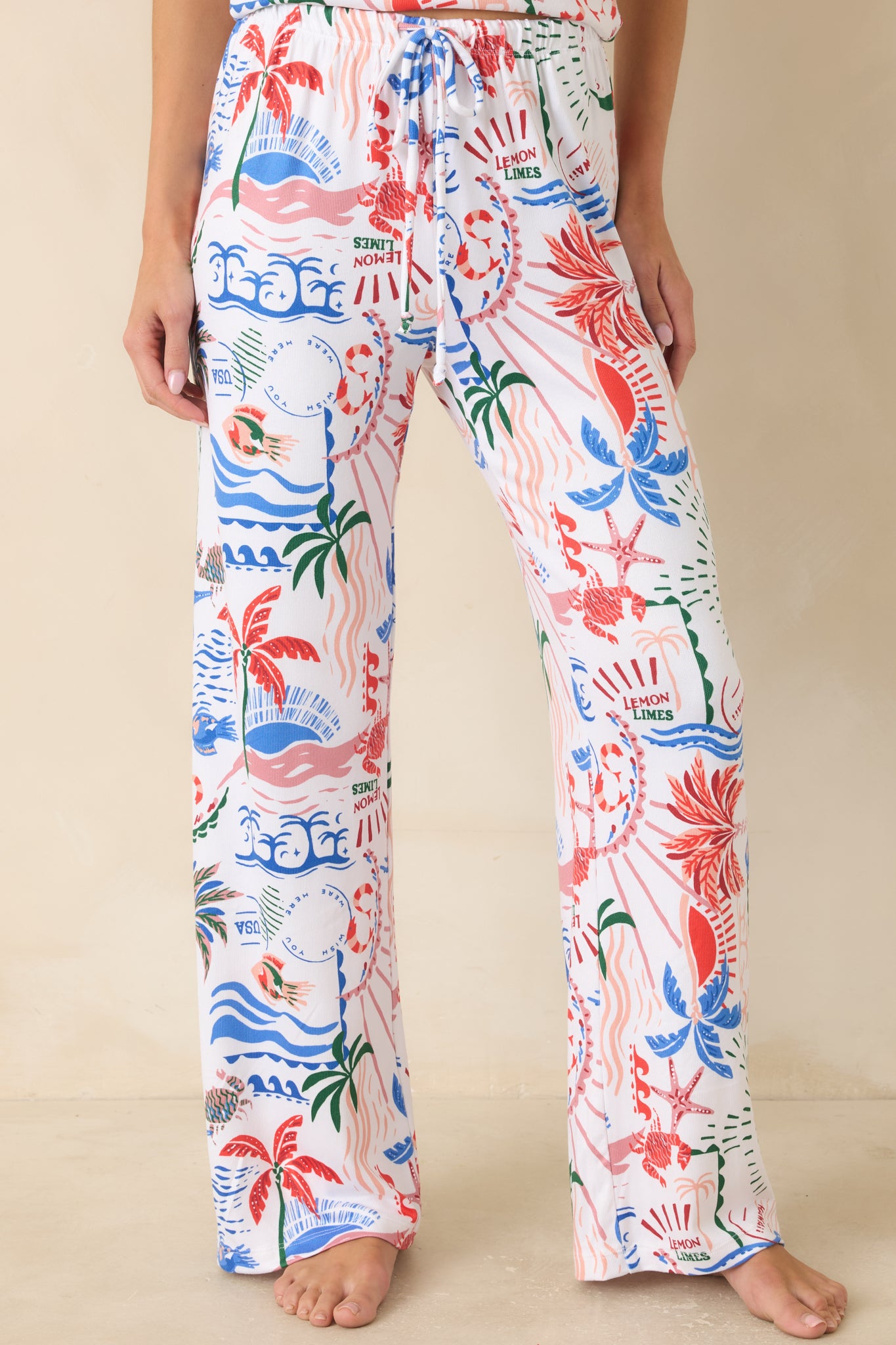 Tropical pajama pants with adjustable waist tie, soft drape, and playful allover island-inspired print.