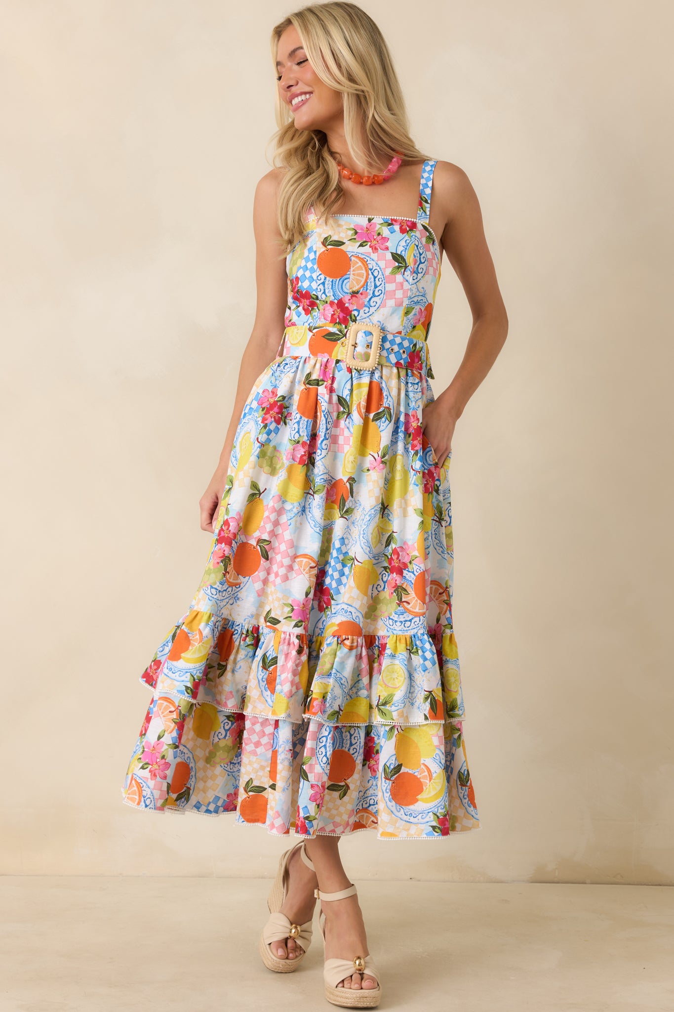 Multi citrus print midi dress in a linen-cotton blend featuring a square neckline, adjustable shoulder straps, and a bright fruit motif throughout.