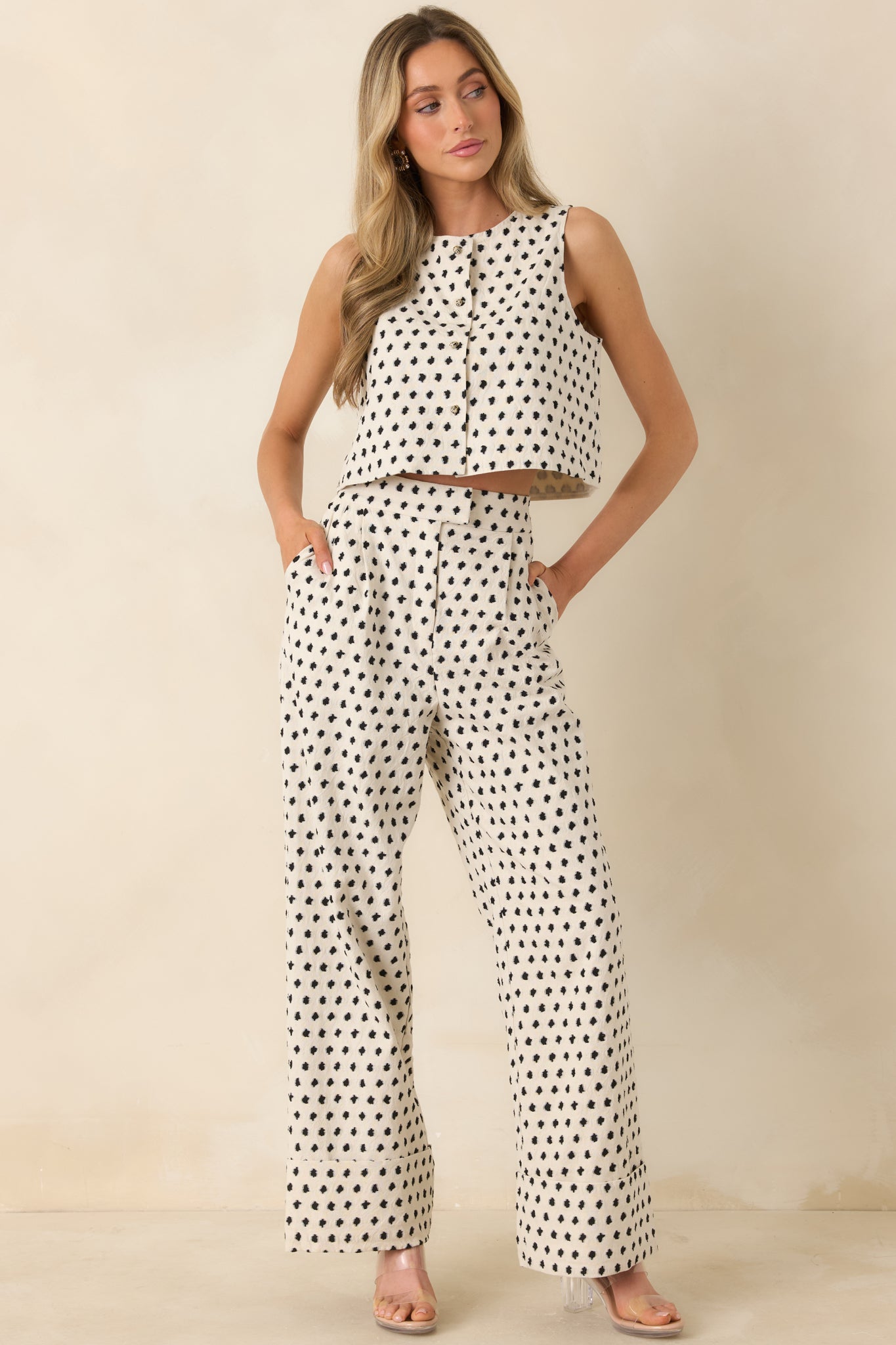 Ivory patterned trousers with flowing wide-leg shape and tailored cuffed hem finish.
