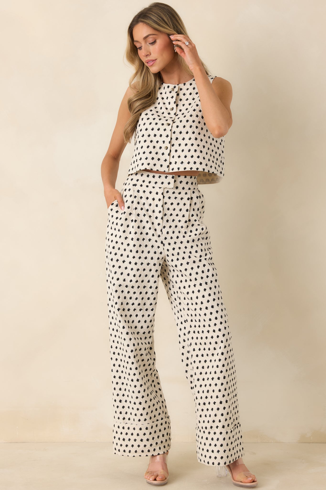 Ivory cotton-linen vest with subtle black pattern and tailored cropped silhouette.