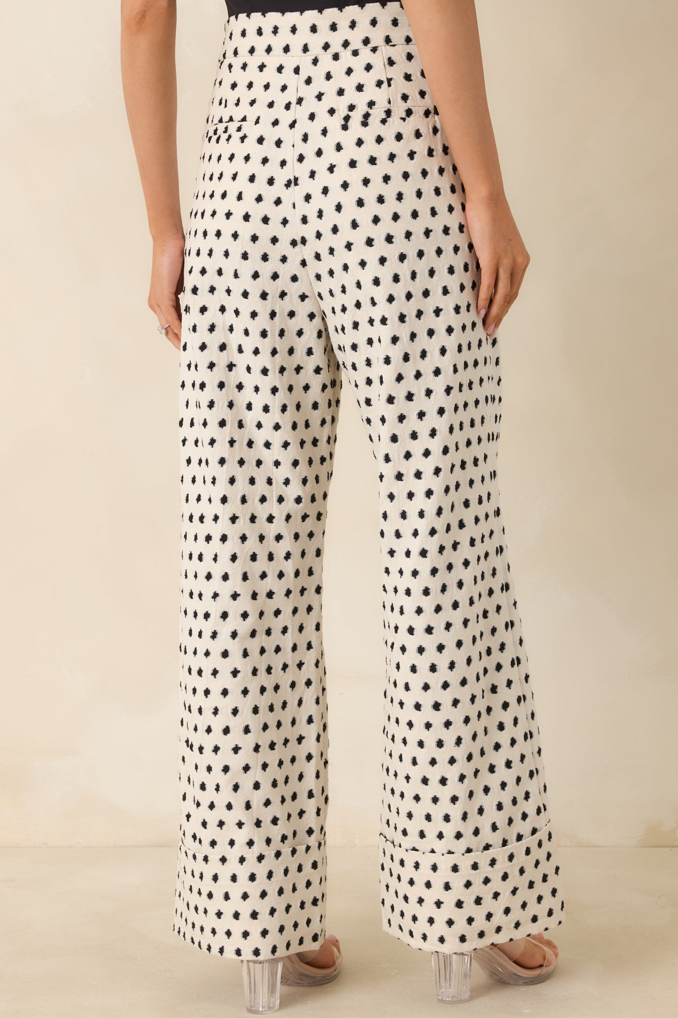 Ivory patterned trousers with faux welt back pockets and clean tailored rear silhouette.