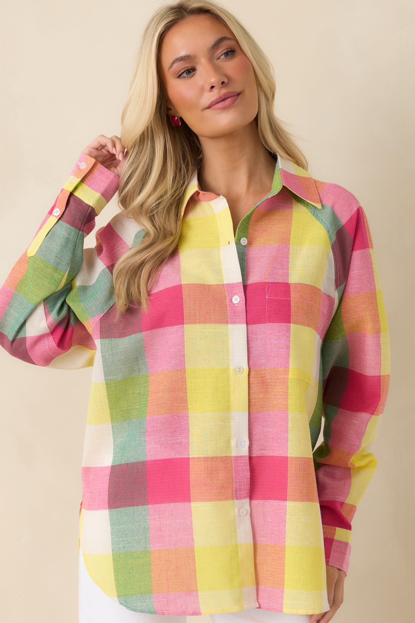 Pink plaid woven top featuring colorful plaid lines, a crisp collar, and a smooth button-front design.