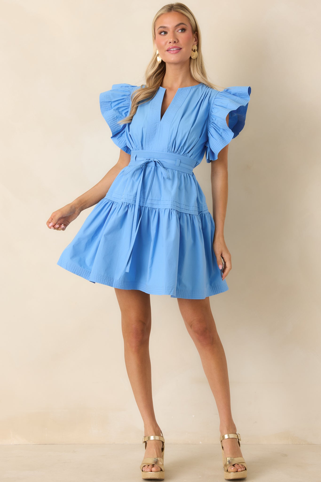 Mini dress with split neckline, flutter sleeves, and tiered skirt
