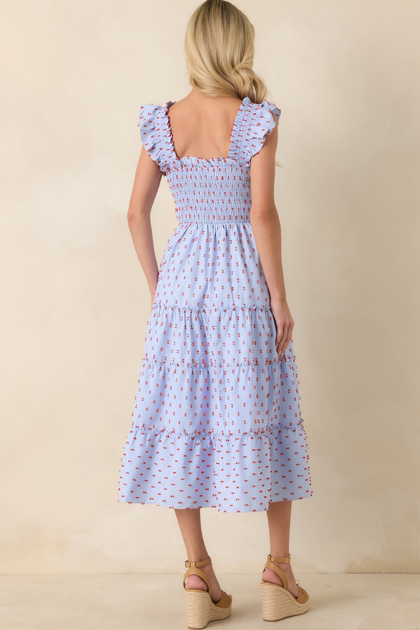 Rear view of the blue gingham midi dress featuring a fully smocked bodice, ruffled shoulder straps, and a tiered skirt silhouette.