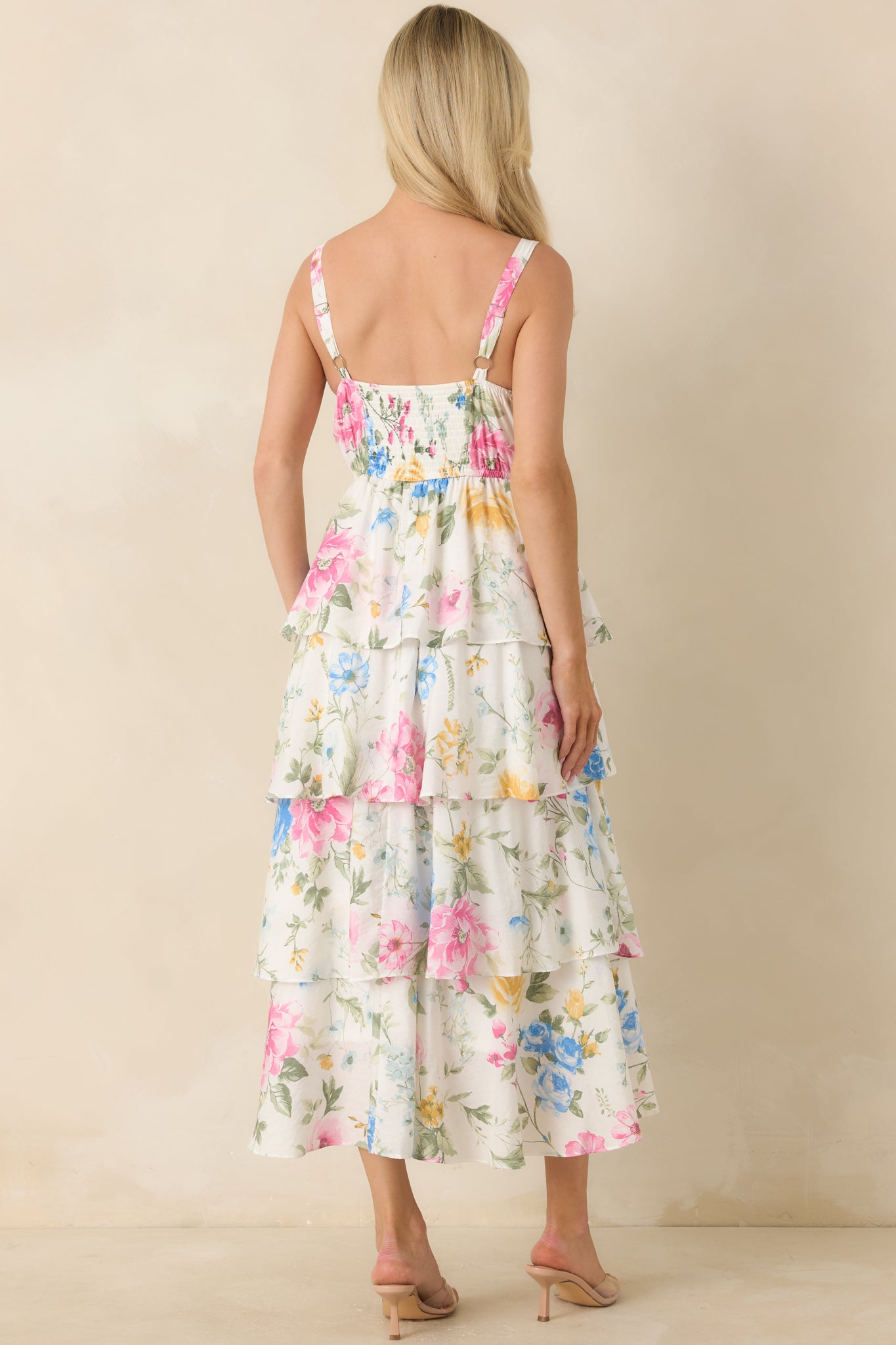 Rear view of floral maxi dress with elasticized smocked back panel and adjustable straps.