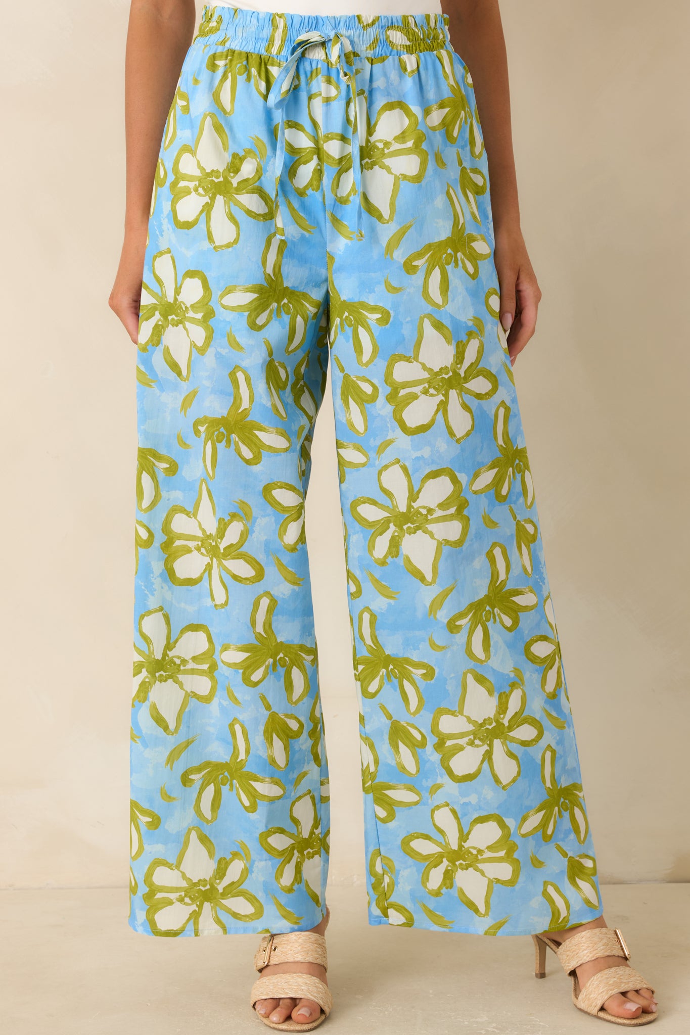Cropped front view of the floral pants highlighting the elastic waistband, adjustable drawstring, and vibrant print.