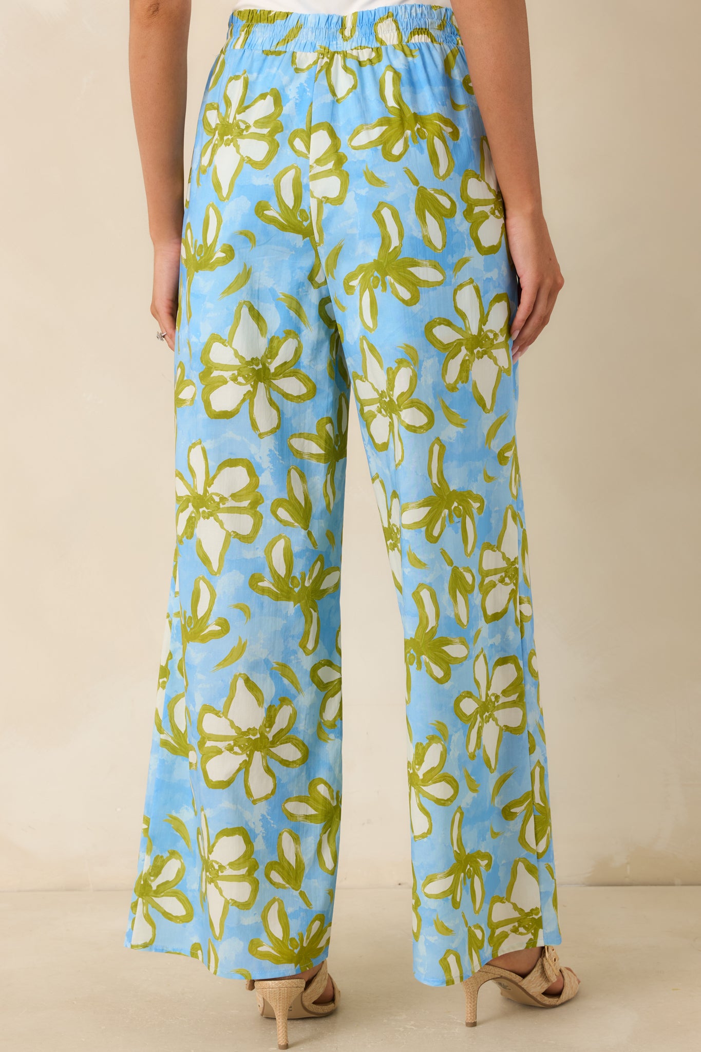 Rear view of the floral wide leg pants featuring a relaxed silhouette, elastic waistband, and flowing full-length fit.
