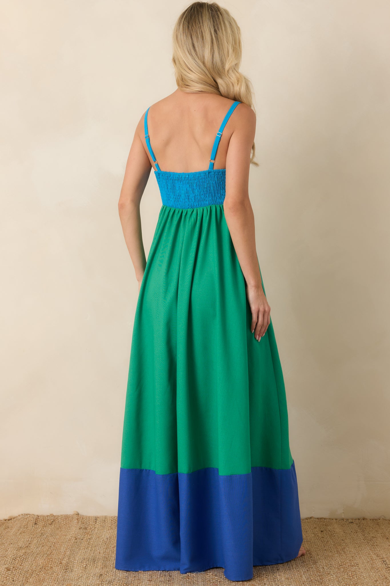 Rear view of the color block maxi dress featuring a smocked back bodice, adjustable straps, and a flowing full-length skirt with contrast hem.