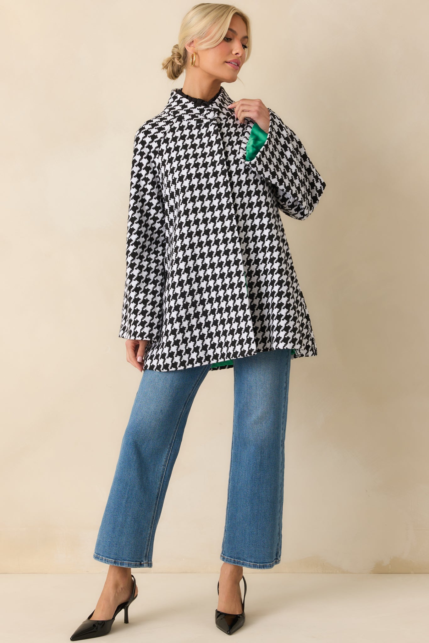 Houndstooth coat highlighting the classic collar, long sleeves, and button-front closure.