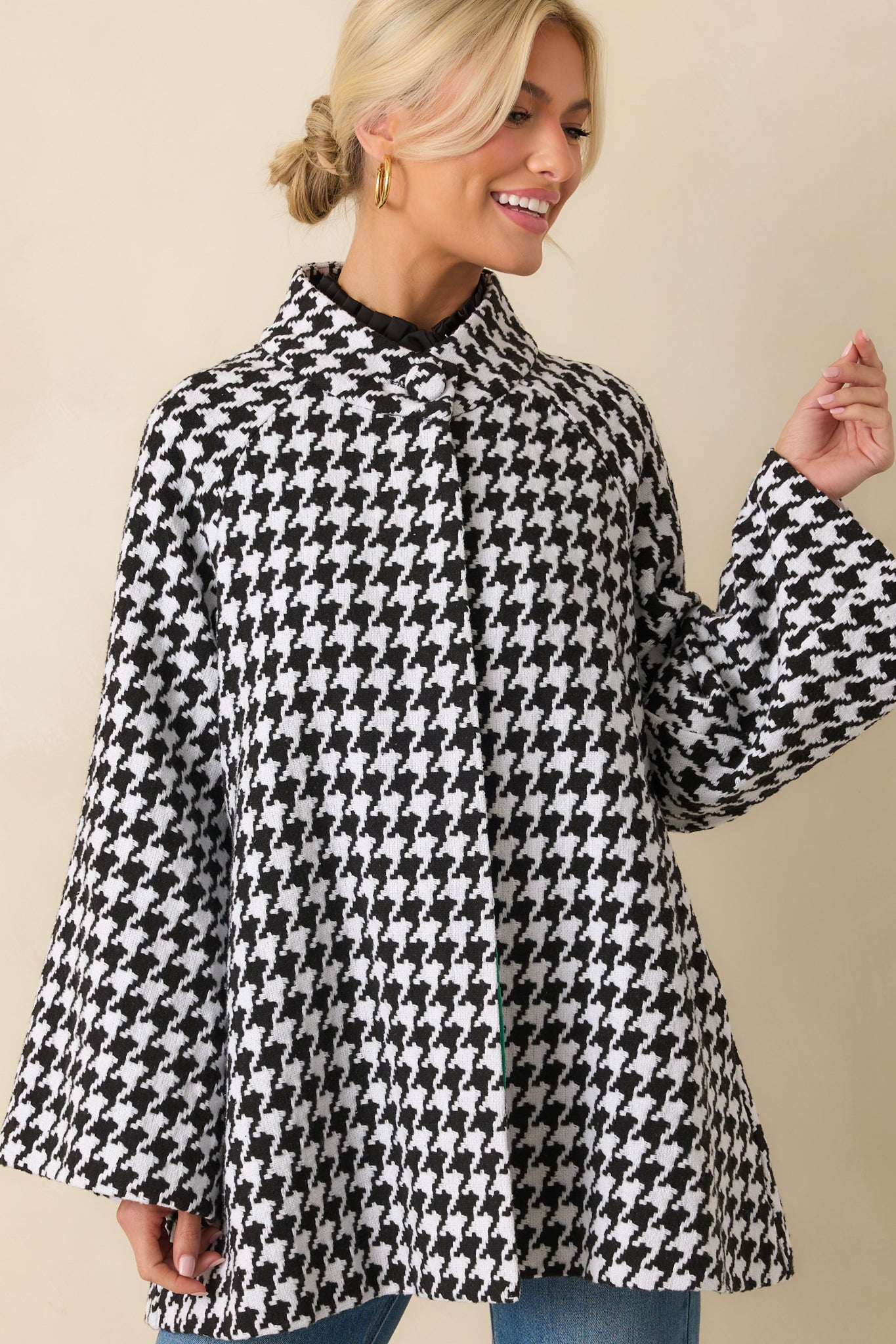 Close-up cropped view highlighting the collared neckline, woven houndstooth pattern, and functional front buttons.