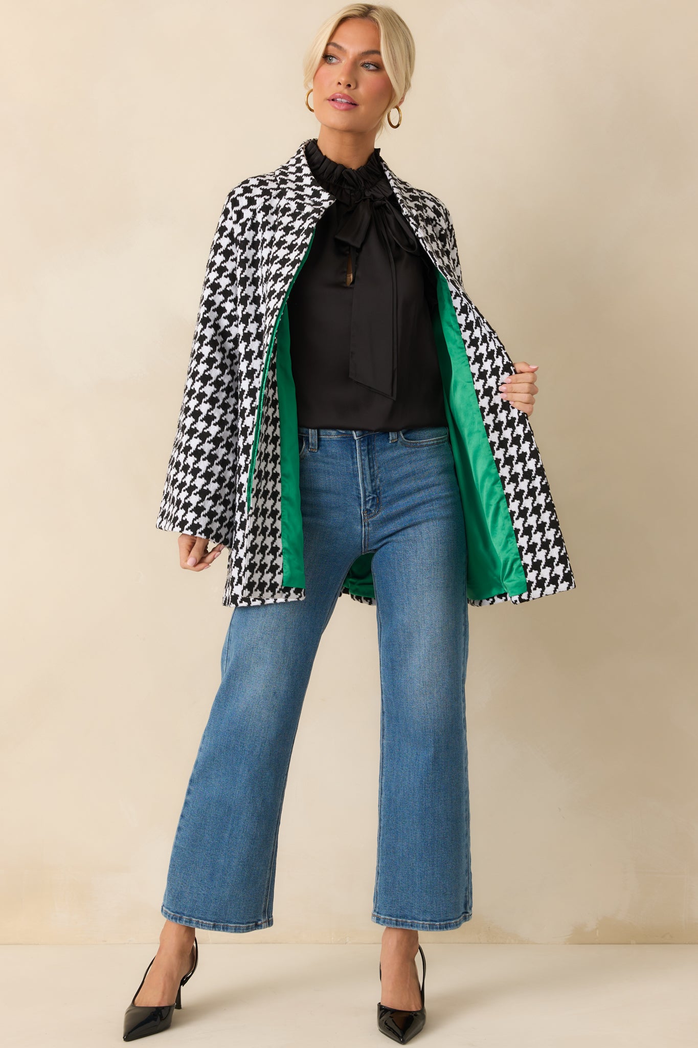 Black-and-white houndstooth coat with a collared neckline, long sleeves, and functional front buttons.