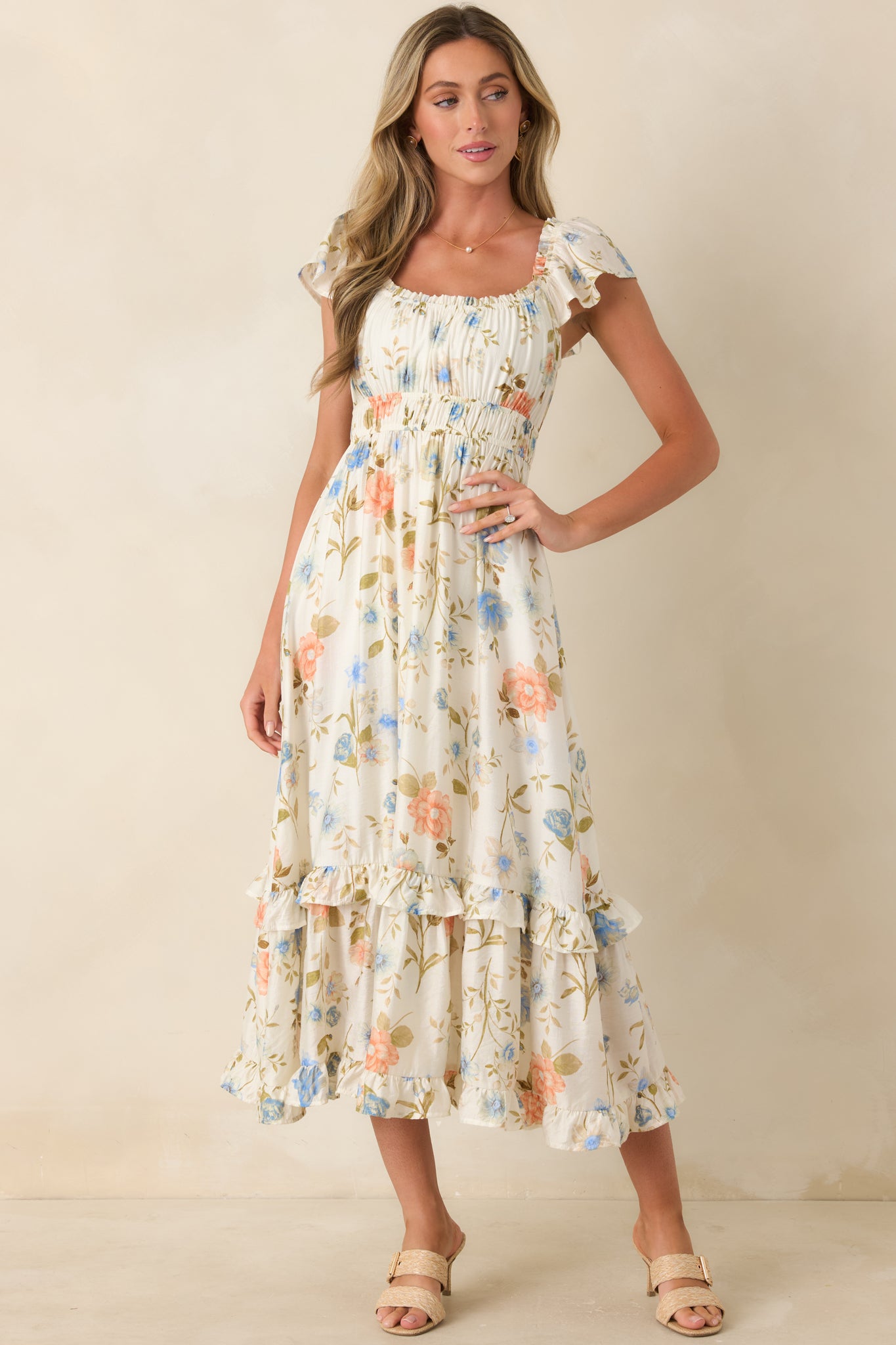 Ivory multi floral midi dress with scoop neckline, flutter sleeves, and gathered bust detail.