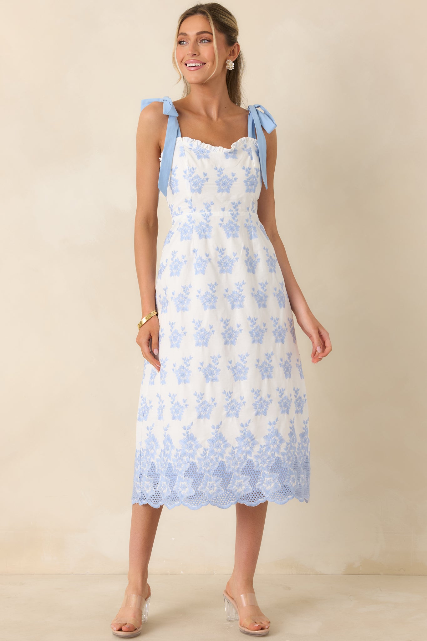 Feminine midi dress with tie straps and embroidered detailing