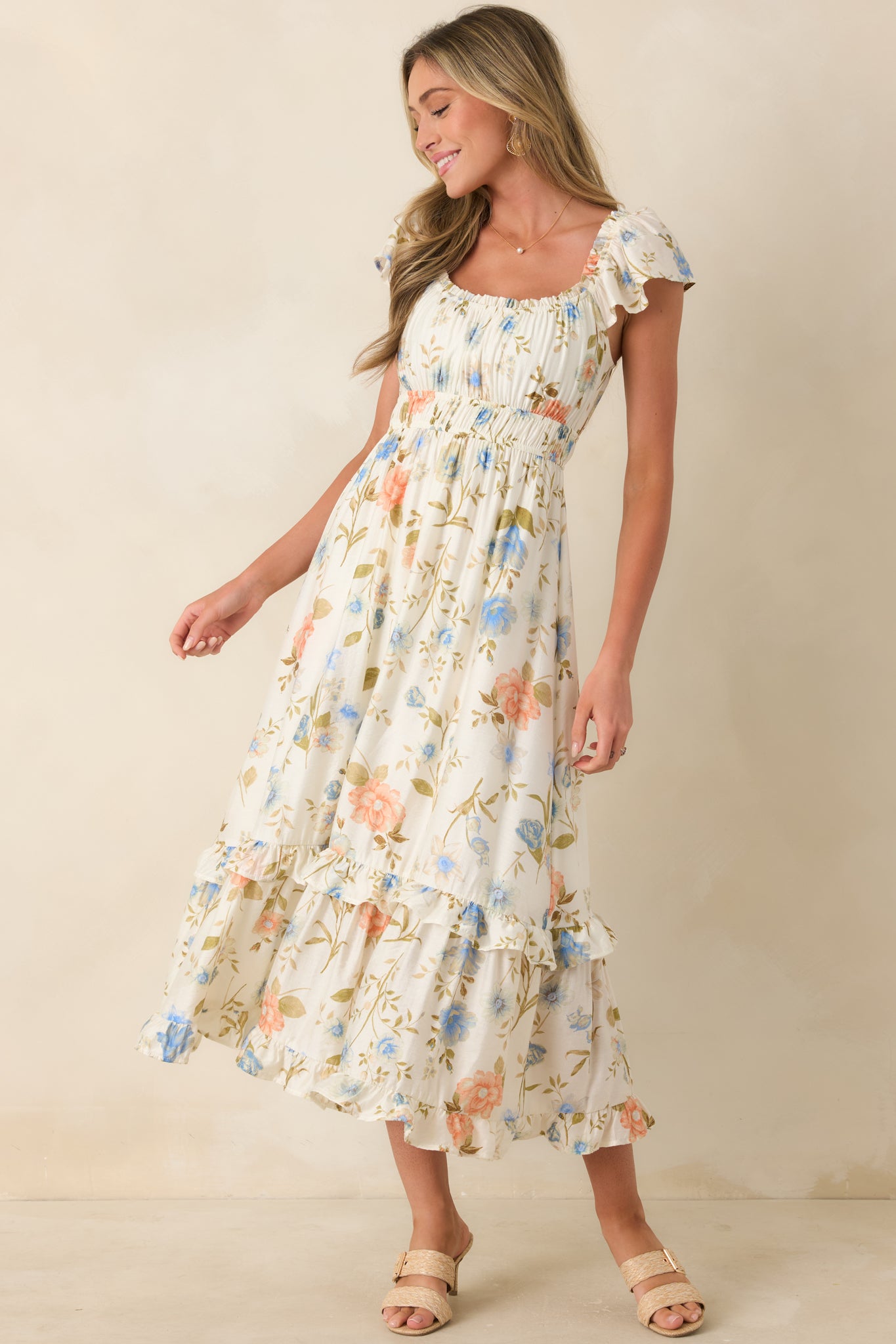 Lightweight floral midi dress featuring elastic waist and softly tiered ruffled skirt.