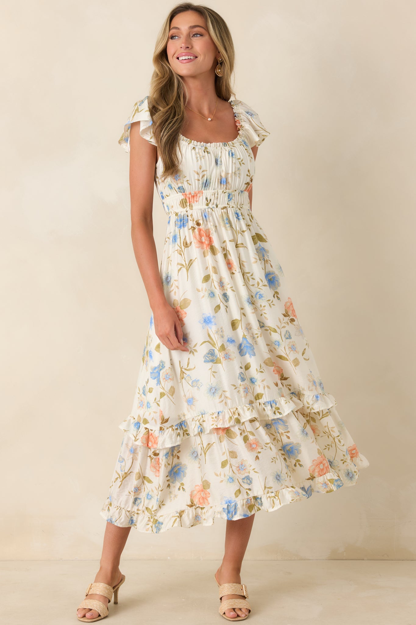 Multi floral midi dress with gathered bust and tiered skirt for added movement.