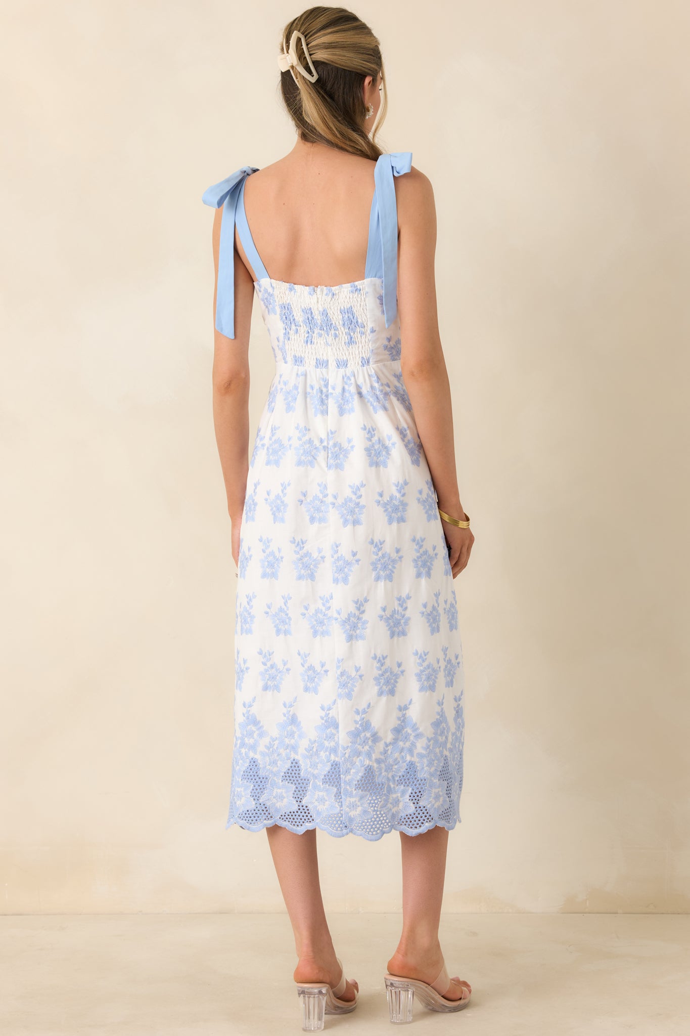 Rear view of embroidered midi dress with flowing skirt and clean finish