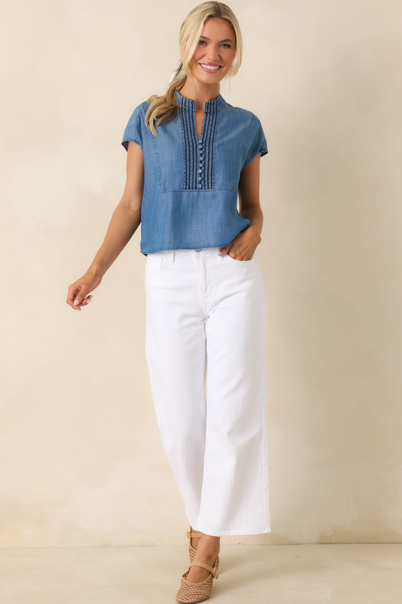 Blue everyday top showcasing a split neckline, structured pintuck accents, and an easy, relaxed fit.