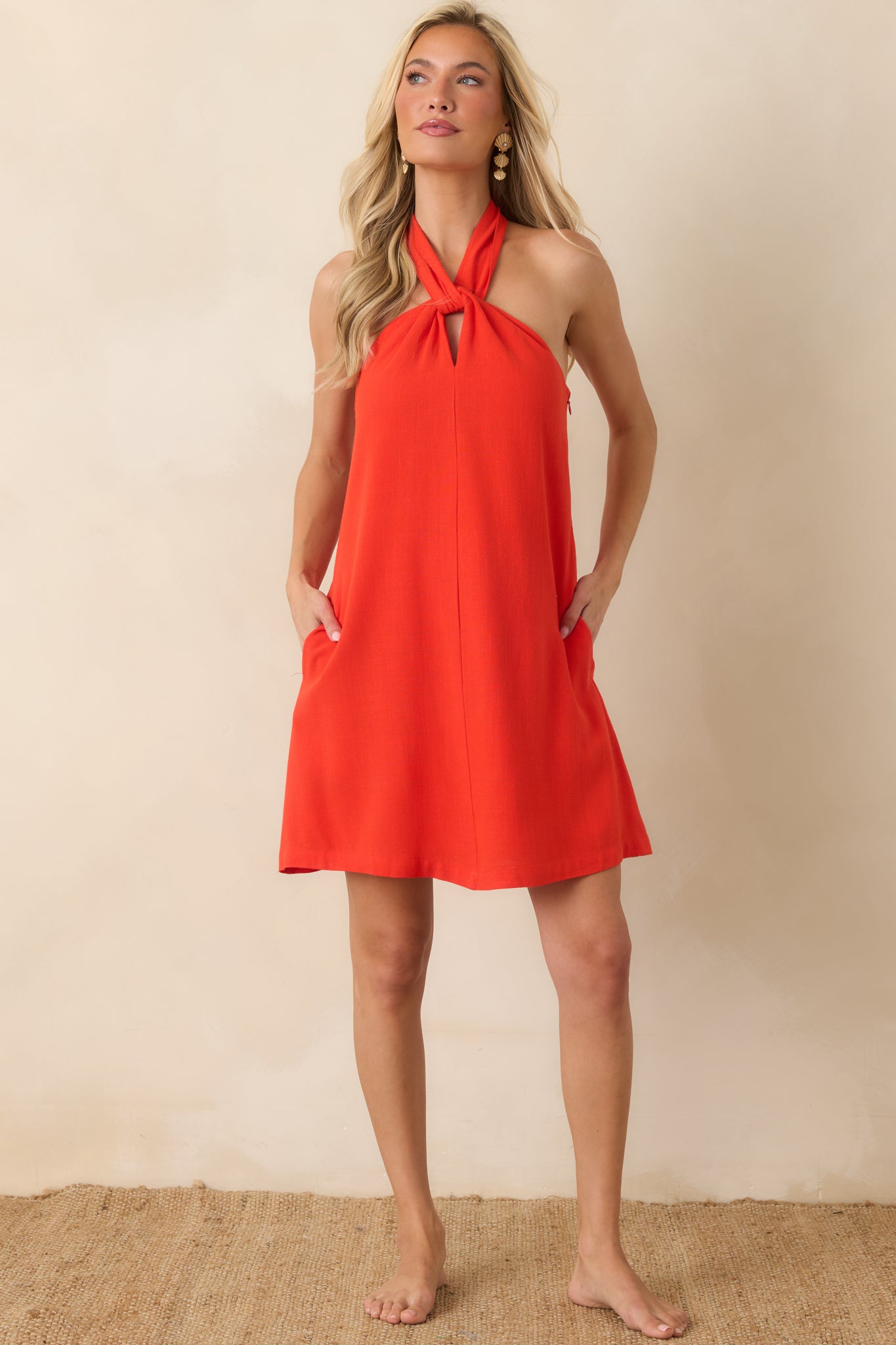 A-line sangria dress showcasing a twisted neckline detail, mini length, and effortless relaxed fit.