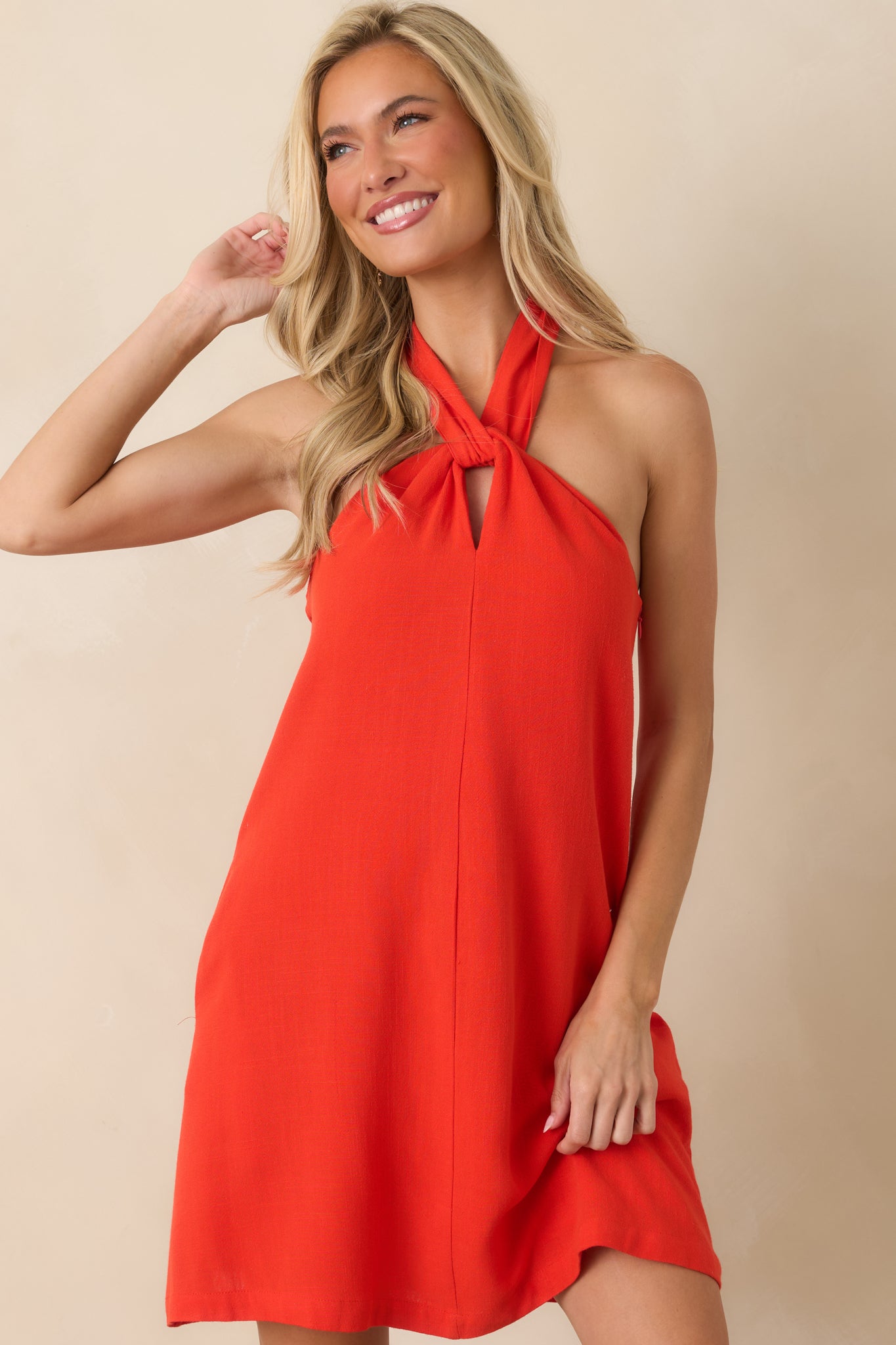Front detail highlighting the elegant neckline construction and relaxed fit of the mini dress.