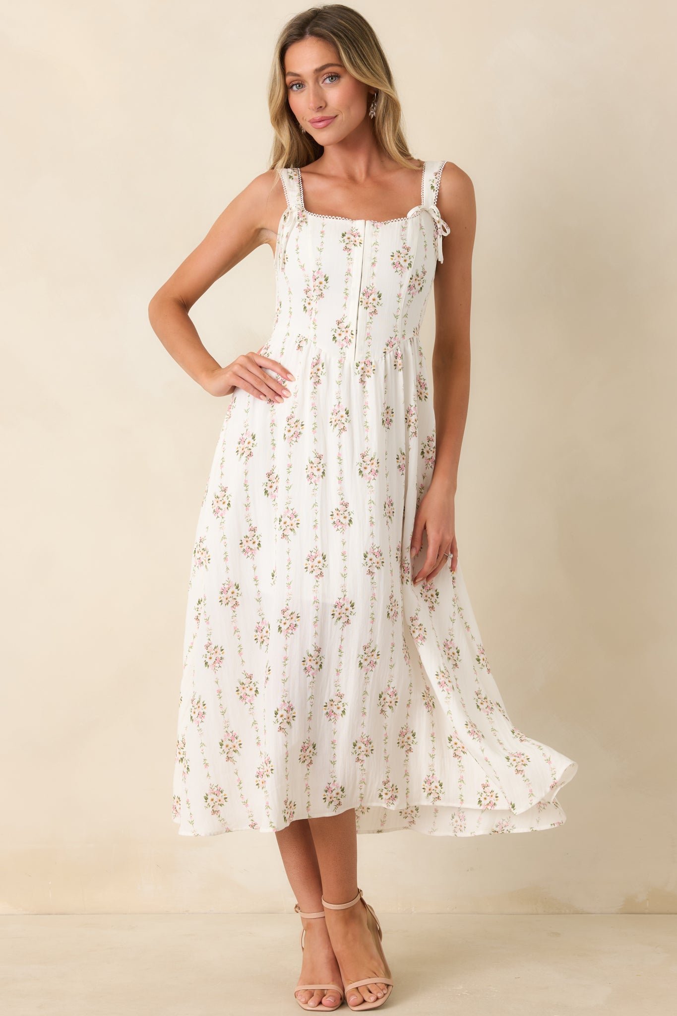 Multi floral midi dress with decorative shoulder tie details, picot edging, and a feminine structured silhouette.