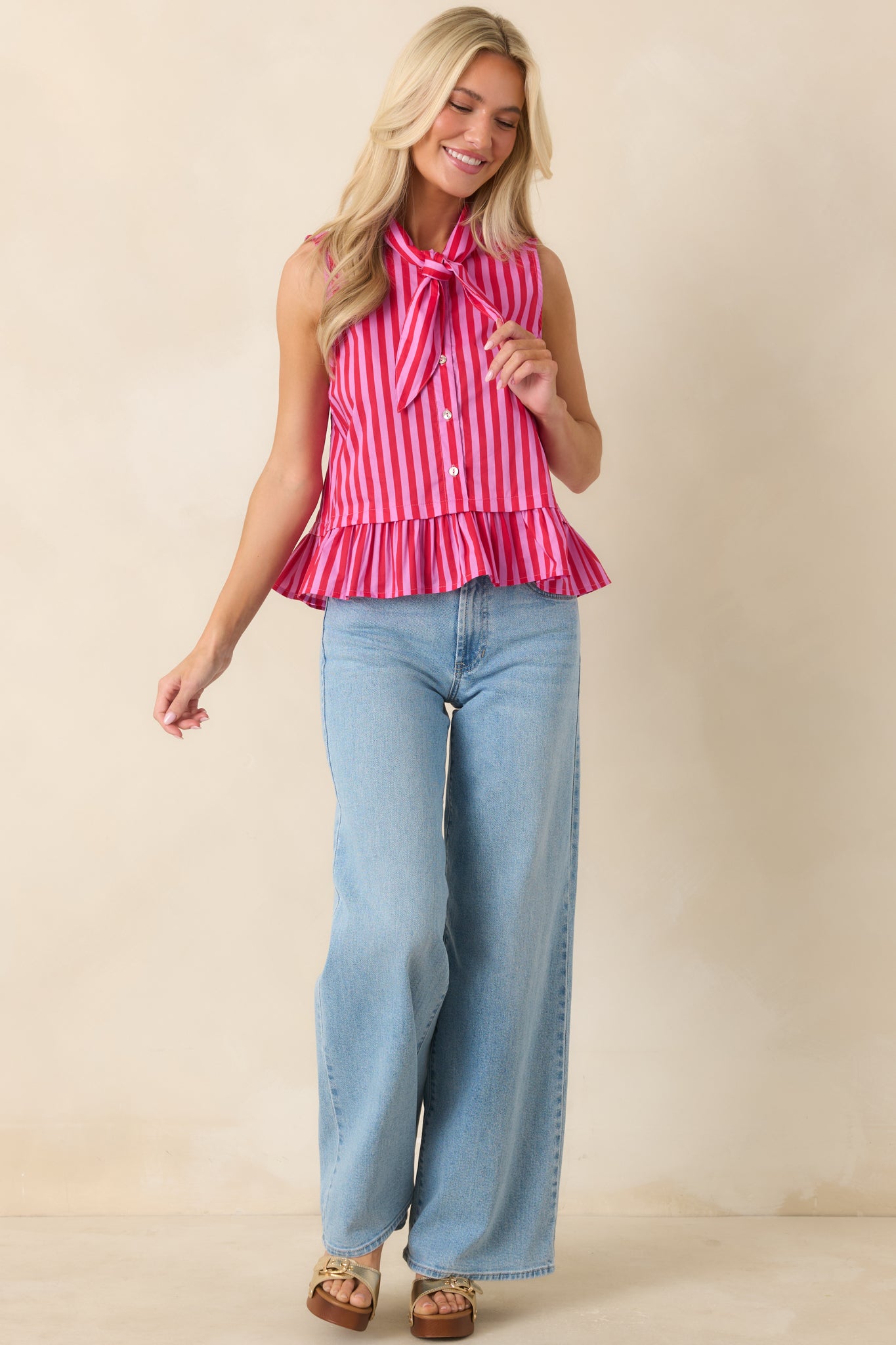 Sleeveless striped top with oversized tie neckline detail and lightweight 100% cotton fabric.