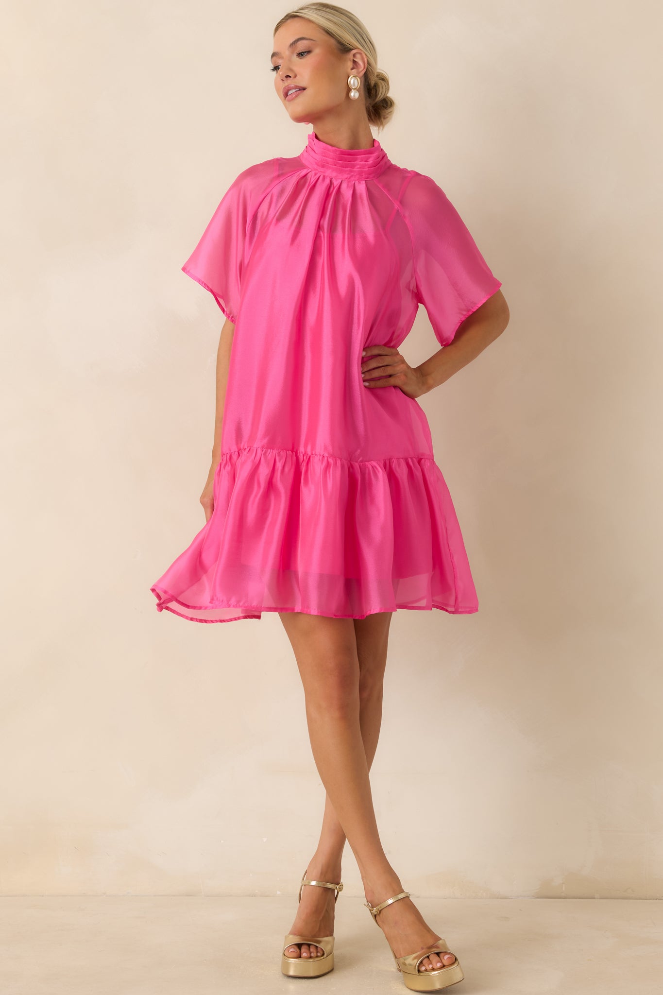 Organza mini dress featuring a polished high neckline, soft drape, and subtly flounced hemline for added movement.