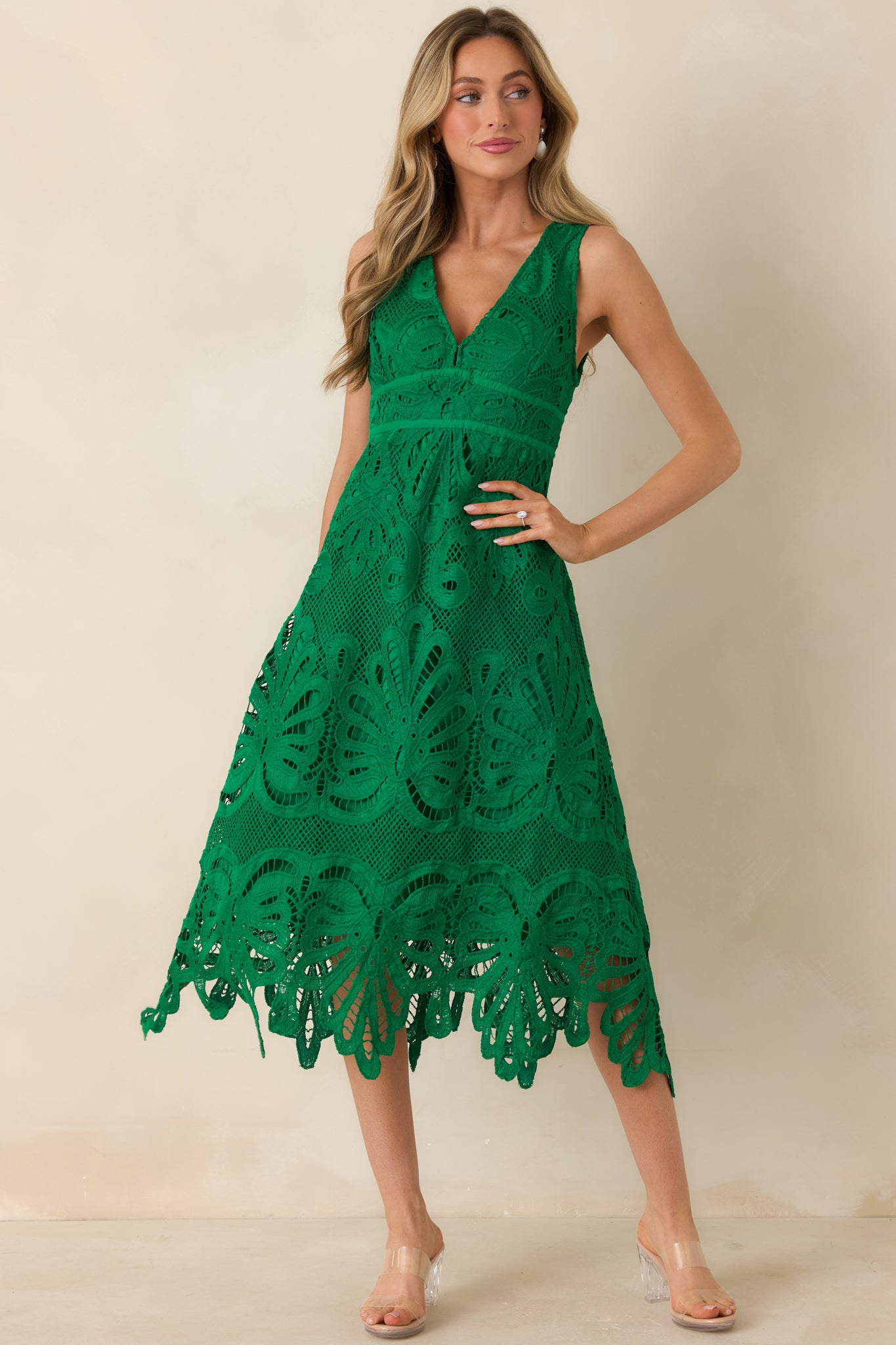 Elegant green lace midi dress with a feminine V-neckline and scalloped hem.