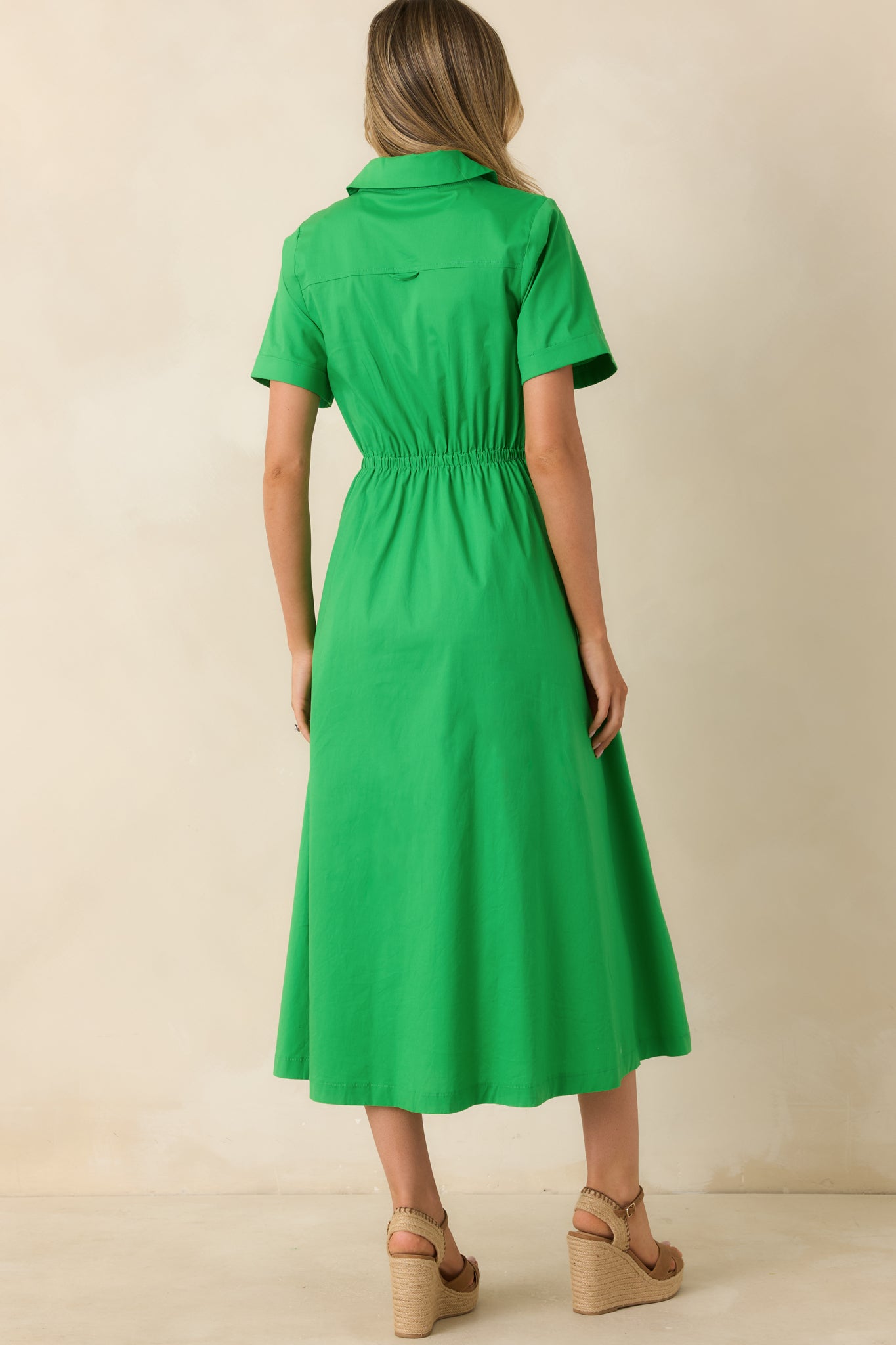 Rear view of the green midi shirt dress featuring an elasticized back waist, short sleeves, and clean tailored construction.