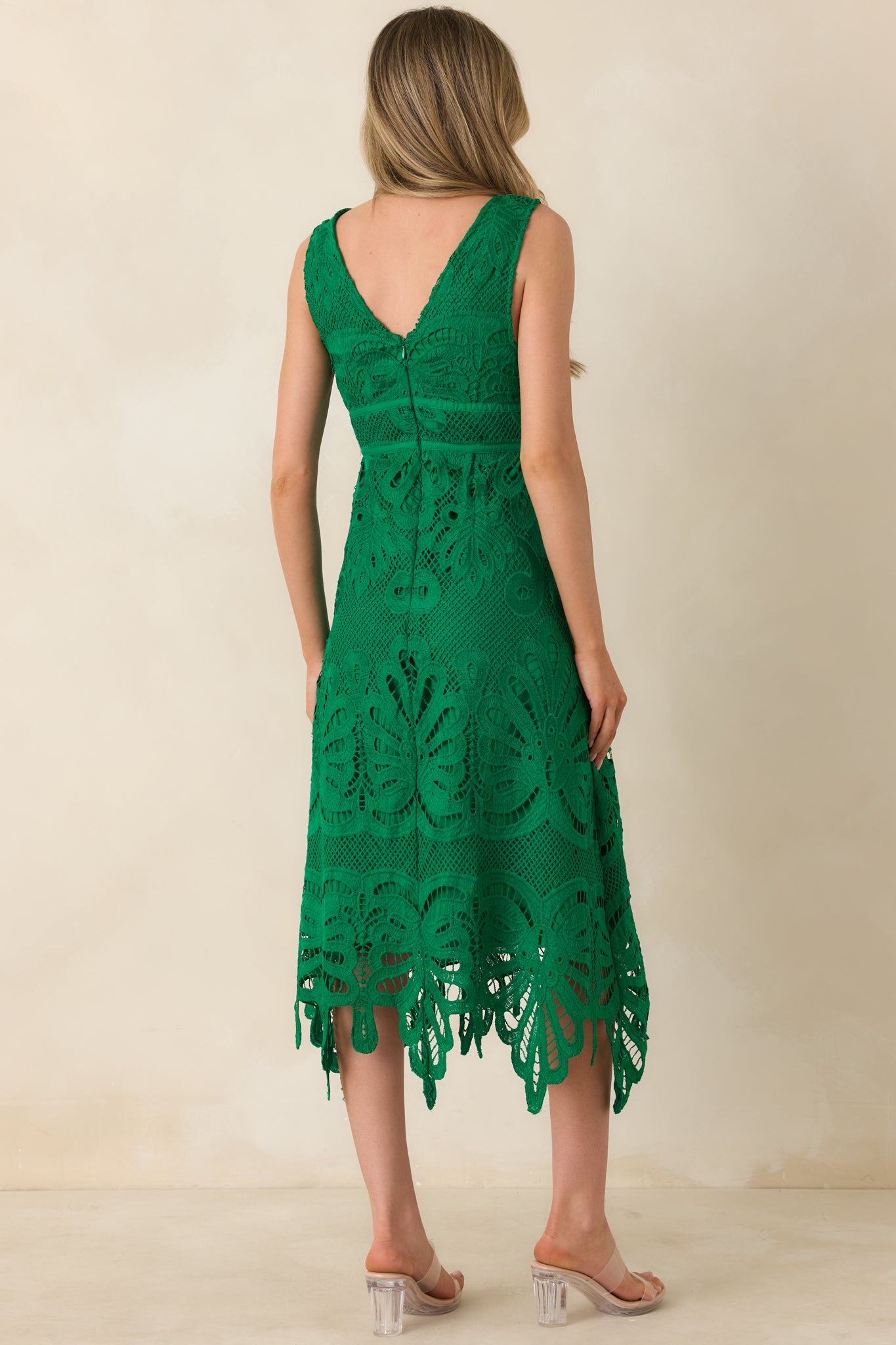 Rear view of the green lace midi dress with a V-back and zipper closure.