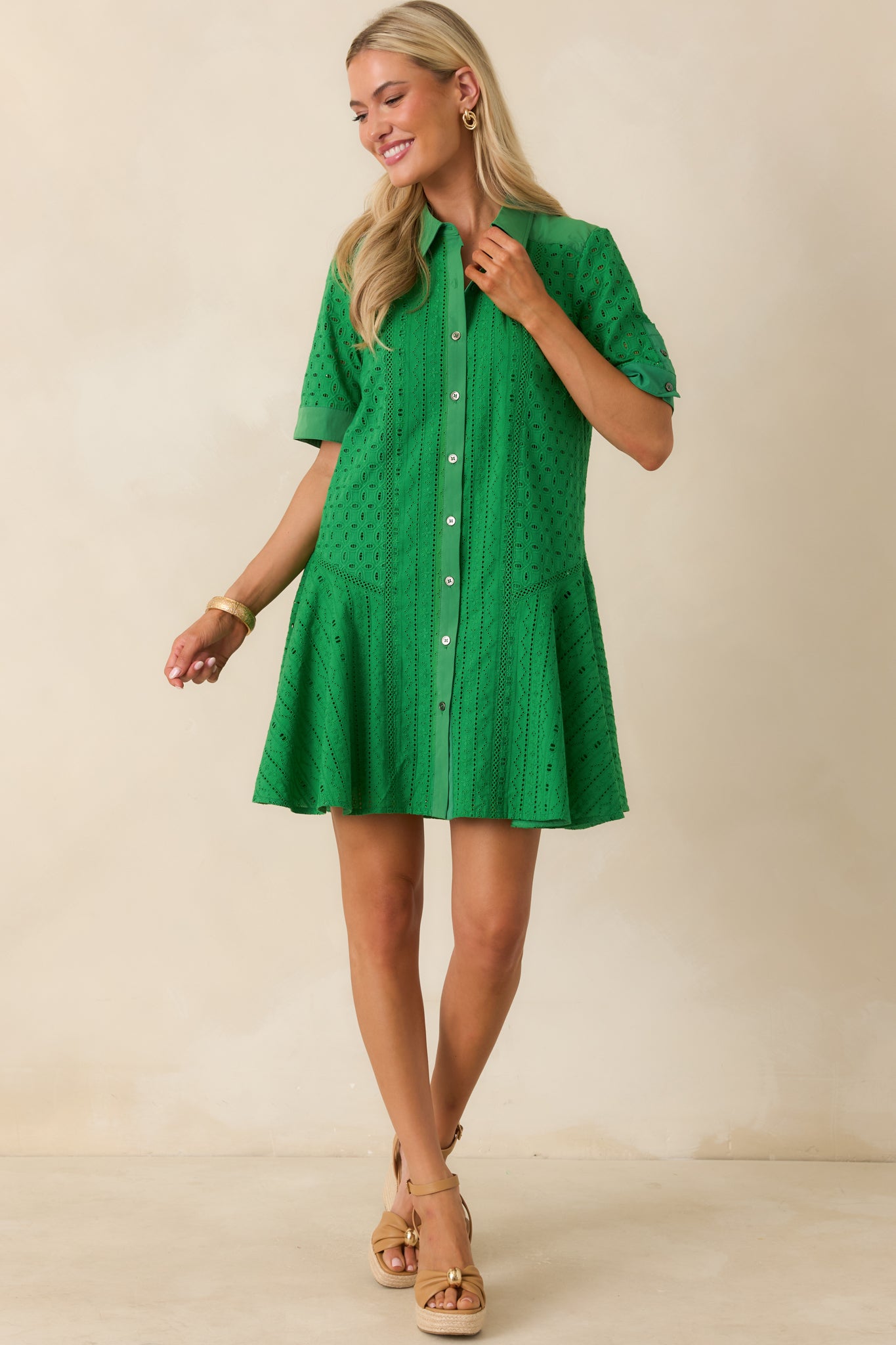 Fit-and-flare eyelet mini dress featuring breathable cotton construction and a polished button-front design.