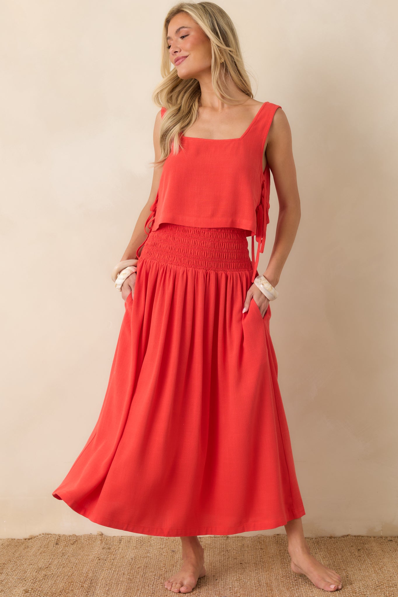 Maxi dress with a fitted smocked bodice, soft volume through the skirt, and an easy silhouette designed for warm-weather comfort.
