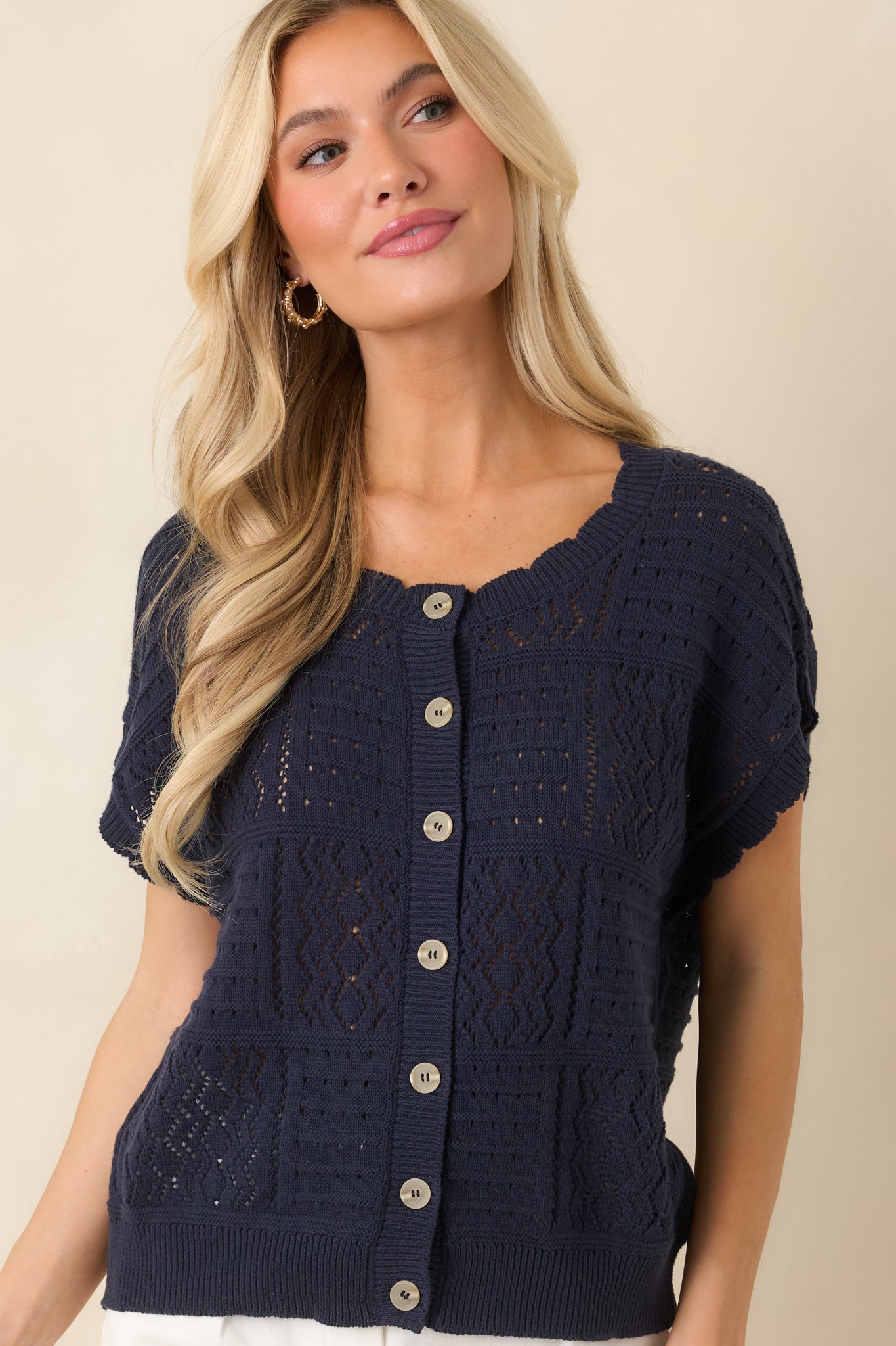 Collared neckline detail on open-knit cardigan with structured yet relaxed finish.