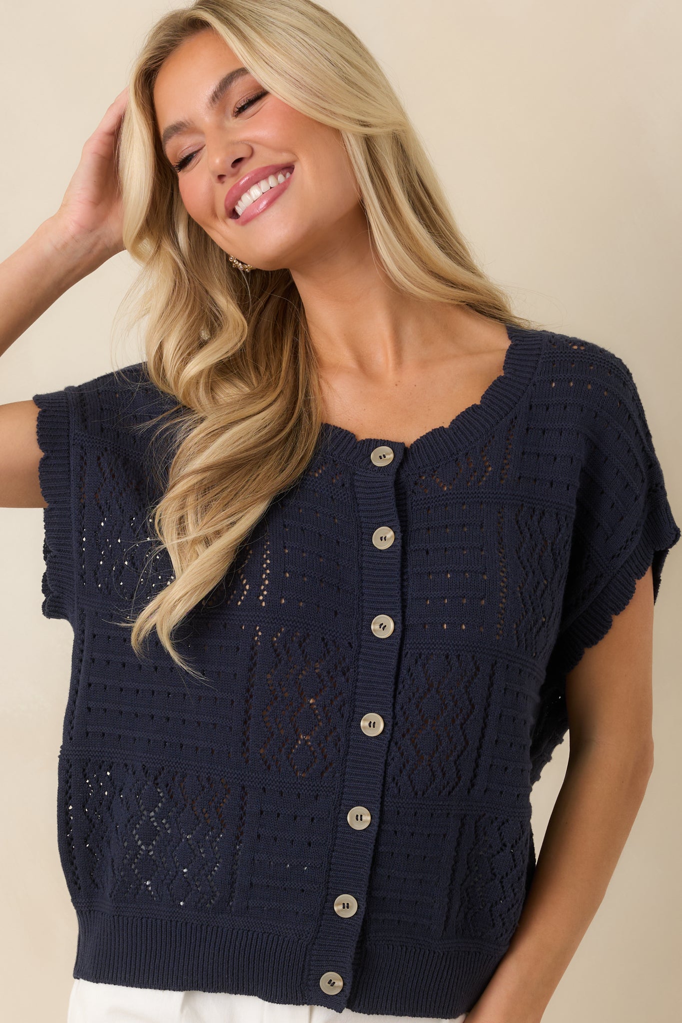 Button-front closure detail on lightweight knit cardigan with classic styling.