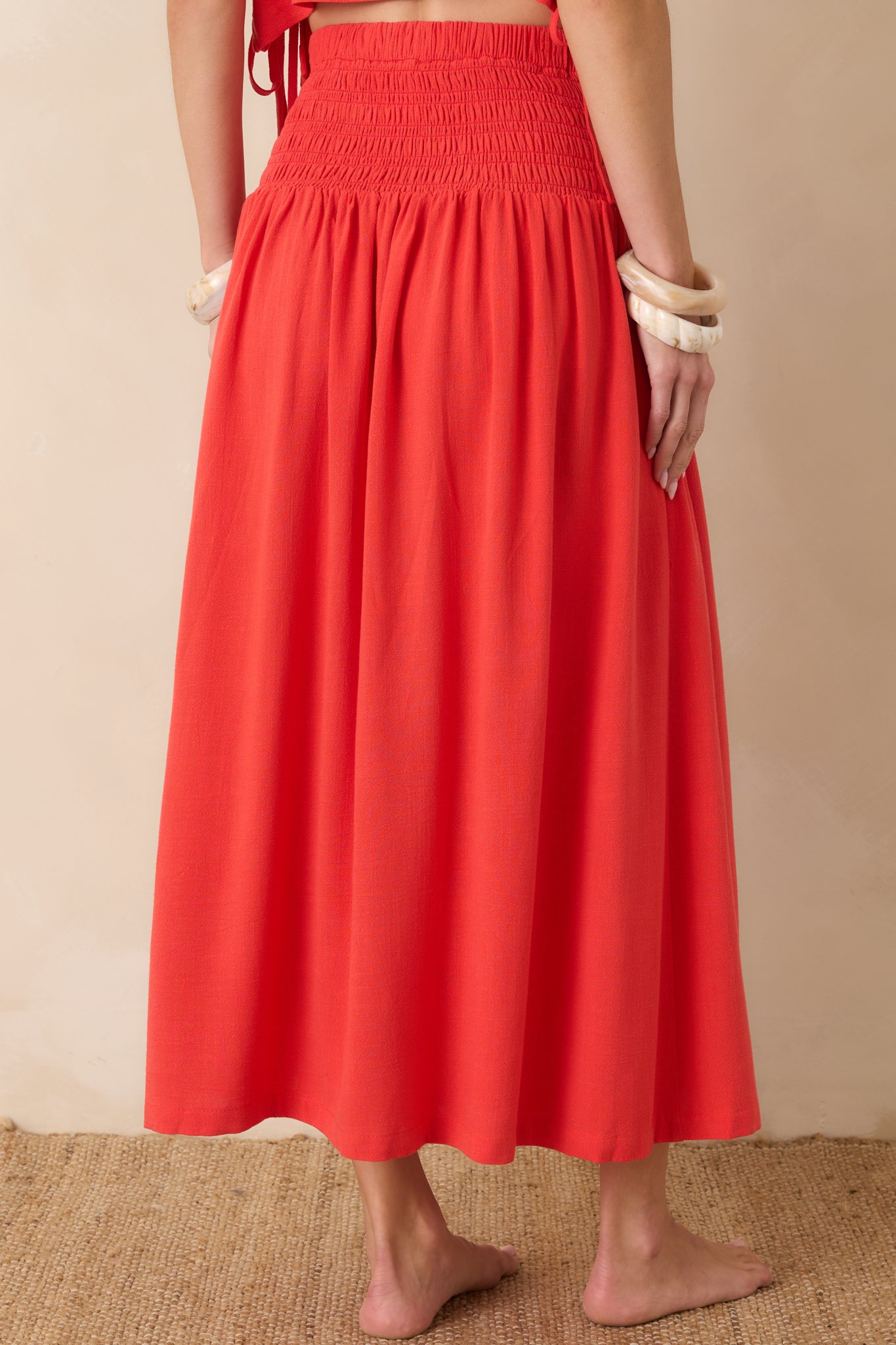 Rear view of the sangria maxi dress featuring a fully smocked bodice, flowing skirt, and soft relaxed silhouette.